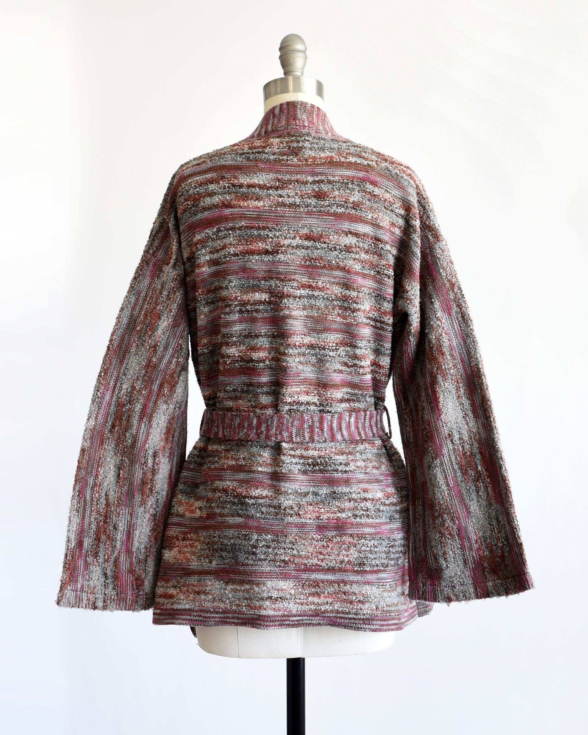 back view of a vintage 1970s space dye wrap cardigan on a dress form against a white background