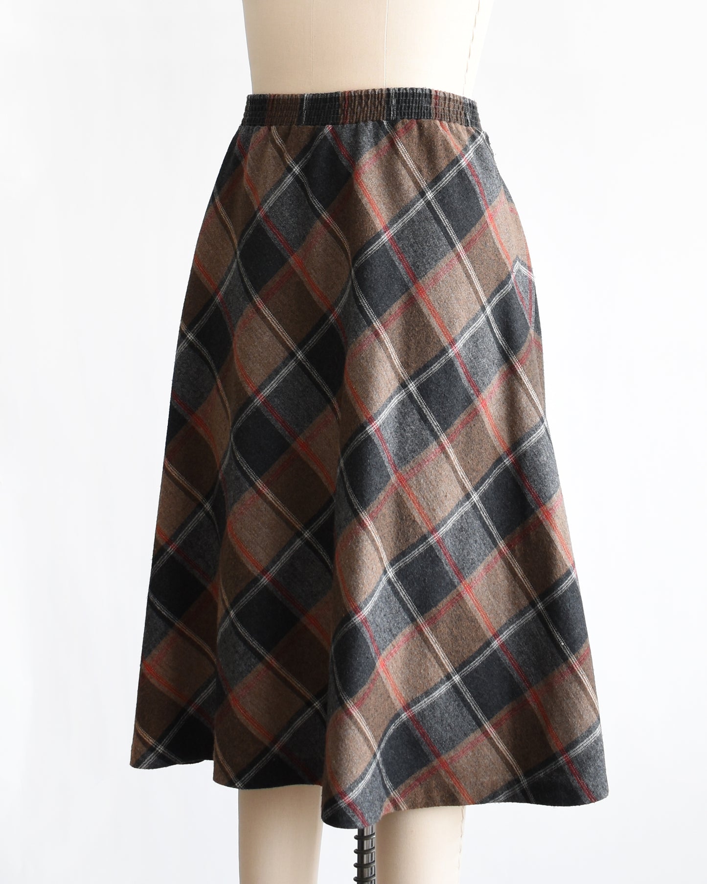 side front view of a vintage 1980s plaid skirt on a mannequin against a white background