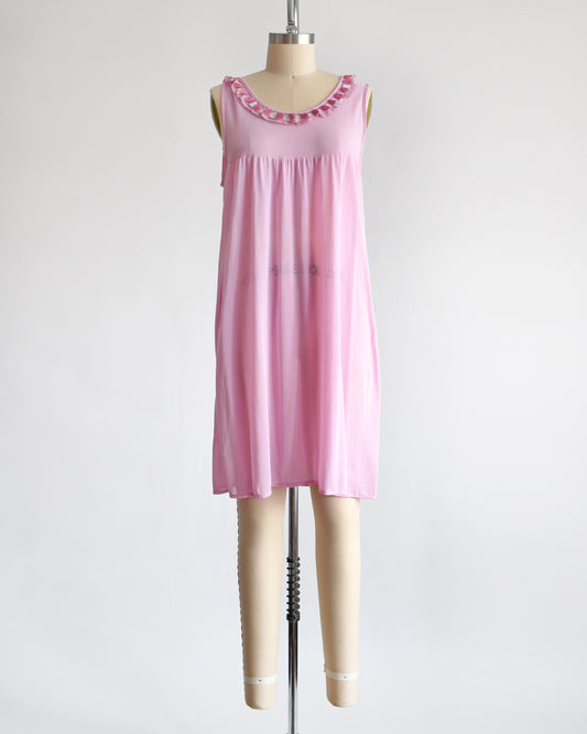 A vintage late 1960s early 1970s pinky purple nightgown with embroidered ruffle trim under the neckline