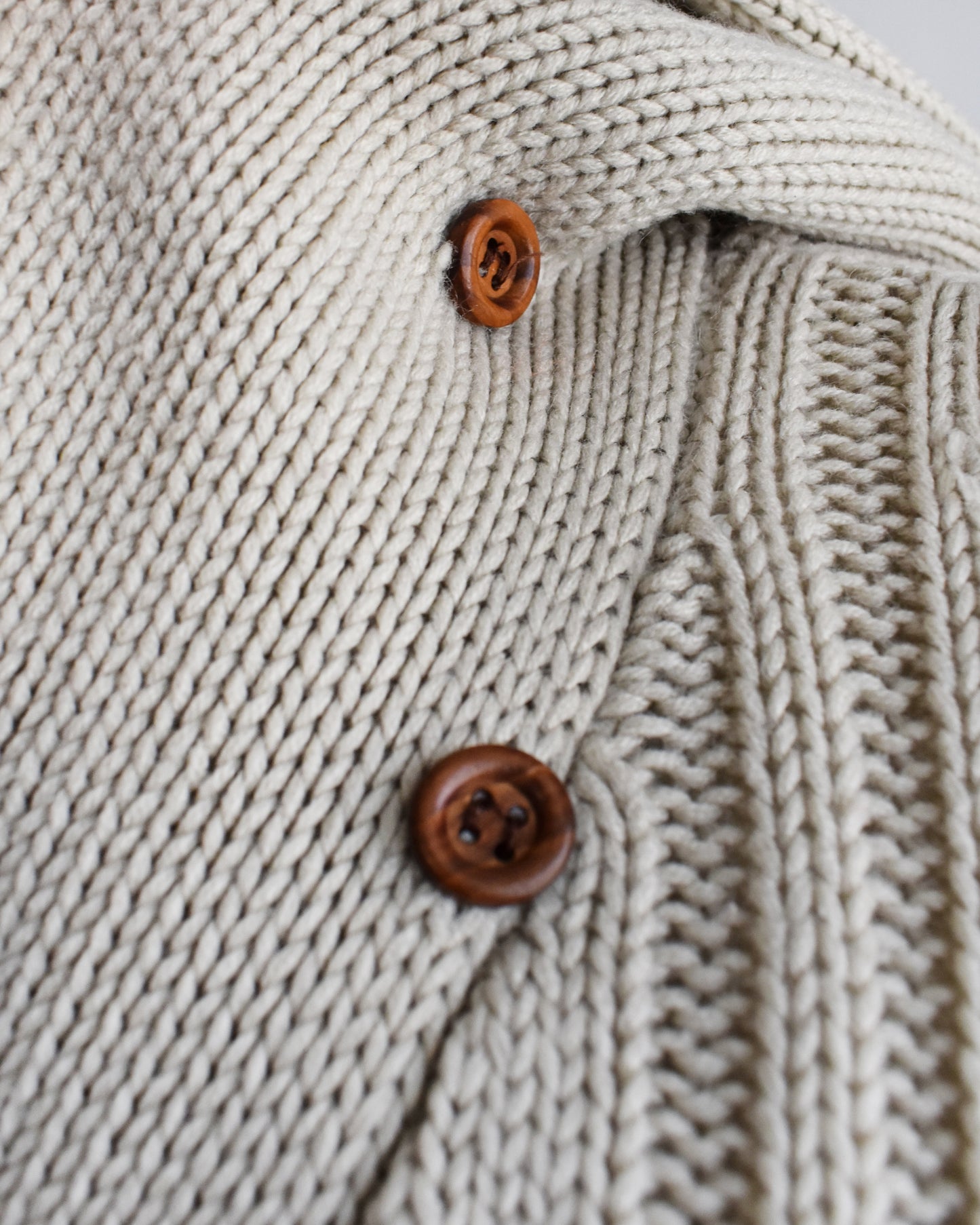 close up of the small buttons under the shawl collar