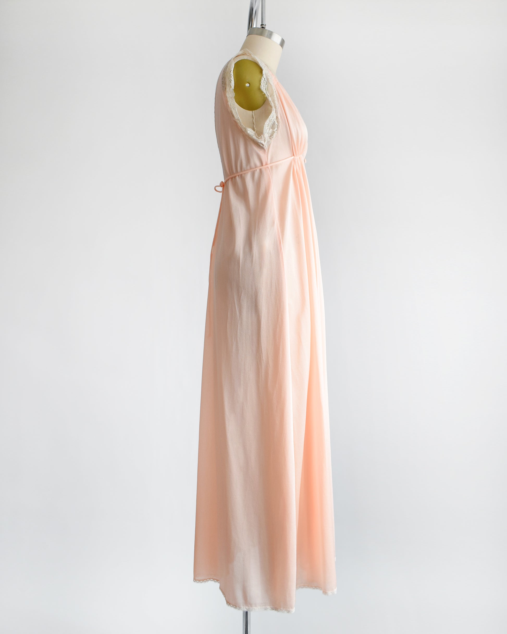 Side view of a vintage 1970s peach nightgown with lace trim