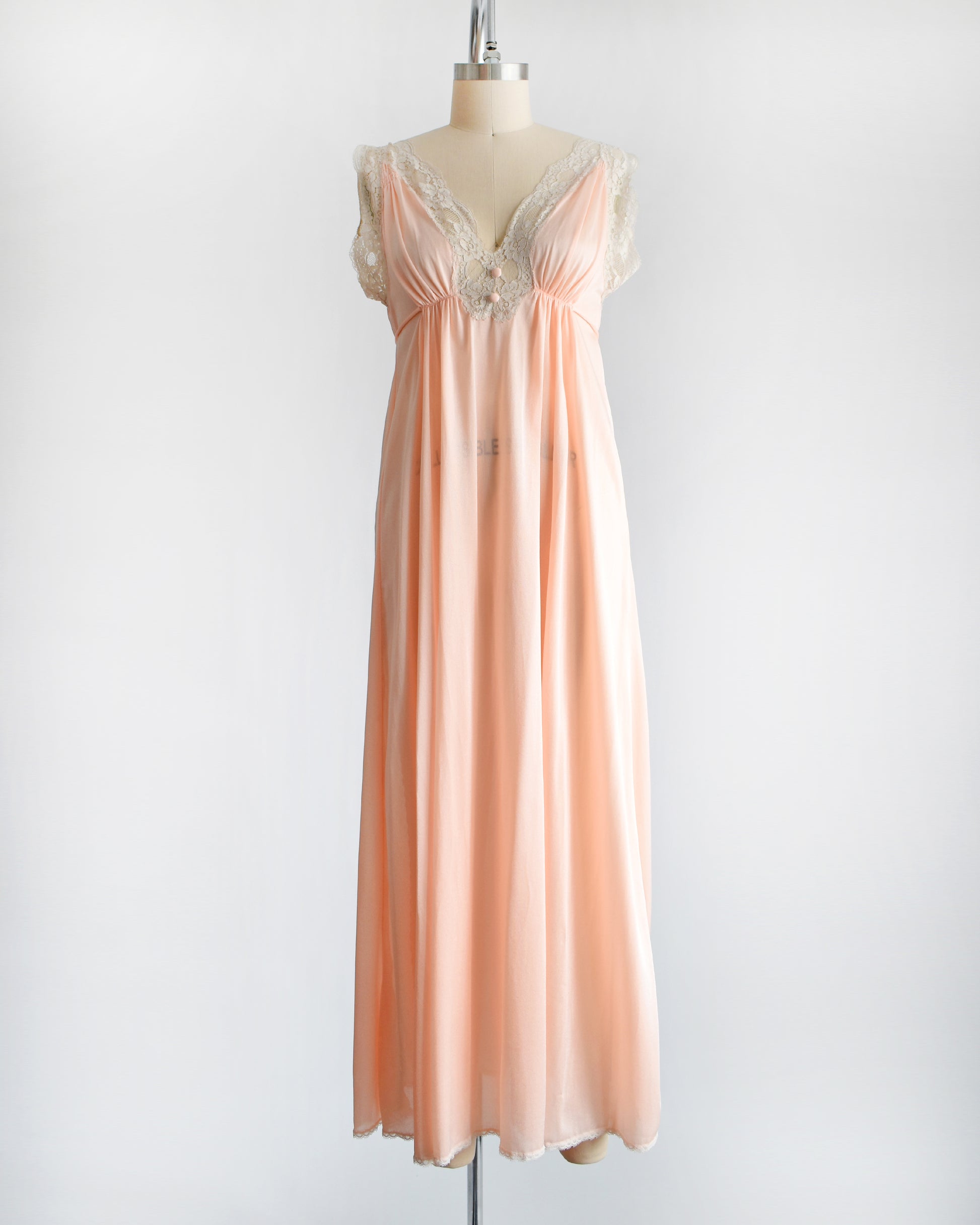 A vintage 1970s peach nightgown with lace trim