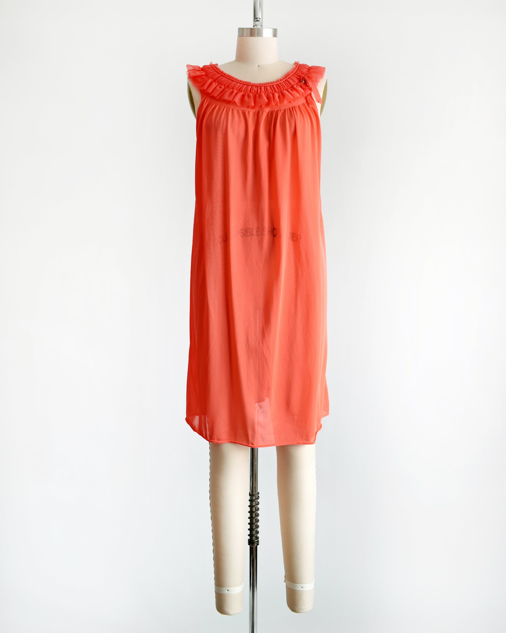 a vintage 1960s/1970s hot coral ruffle nightie that has a ruffled neckline