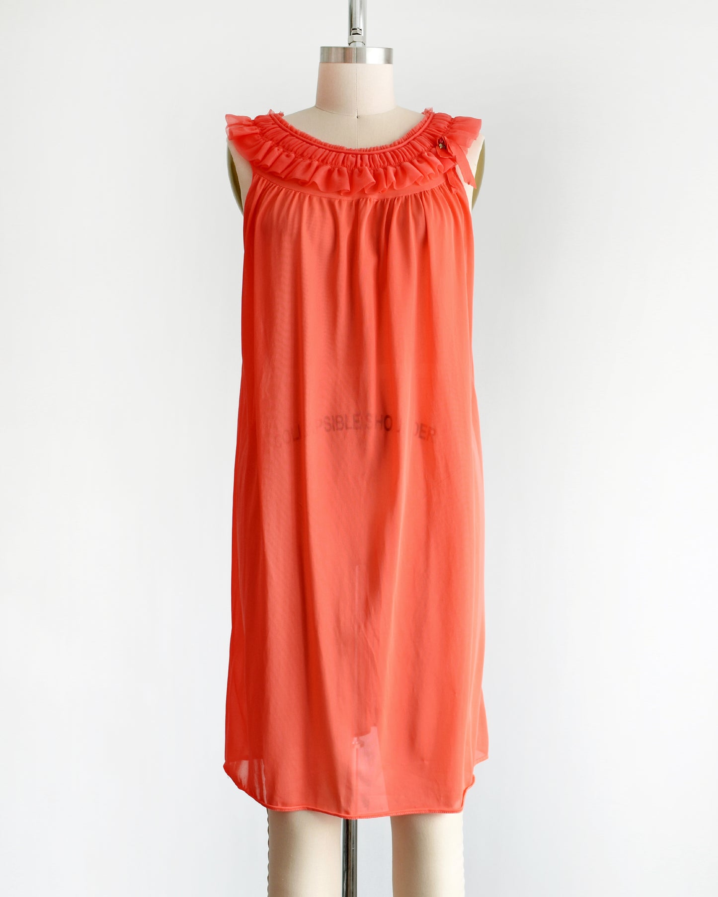 a vintage 1960s/1970s hot coral ruffle nightie that has a ruffled neckline