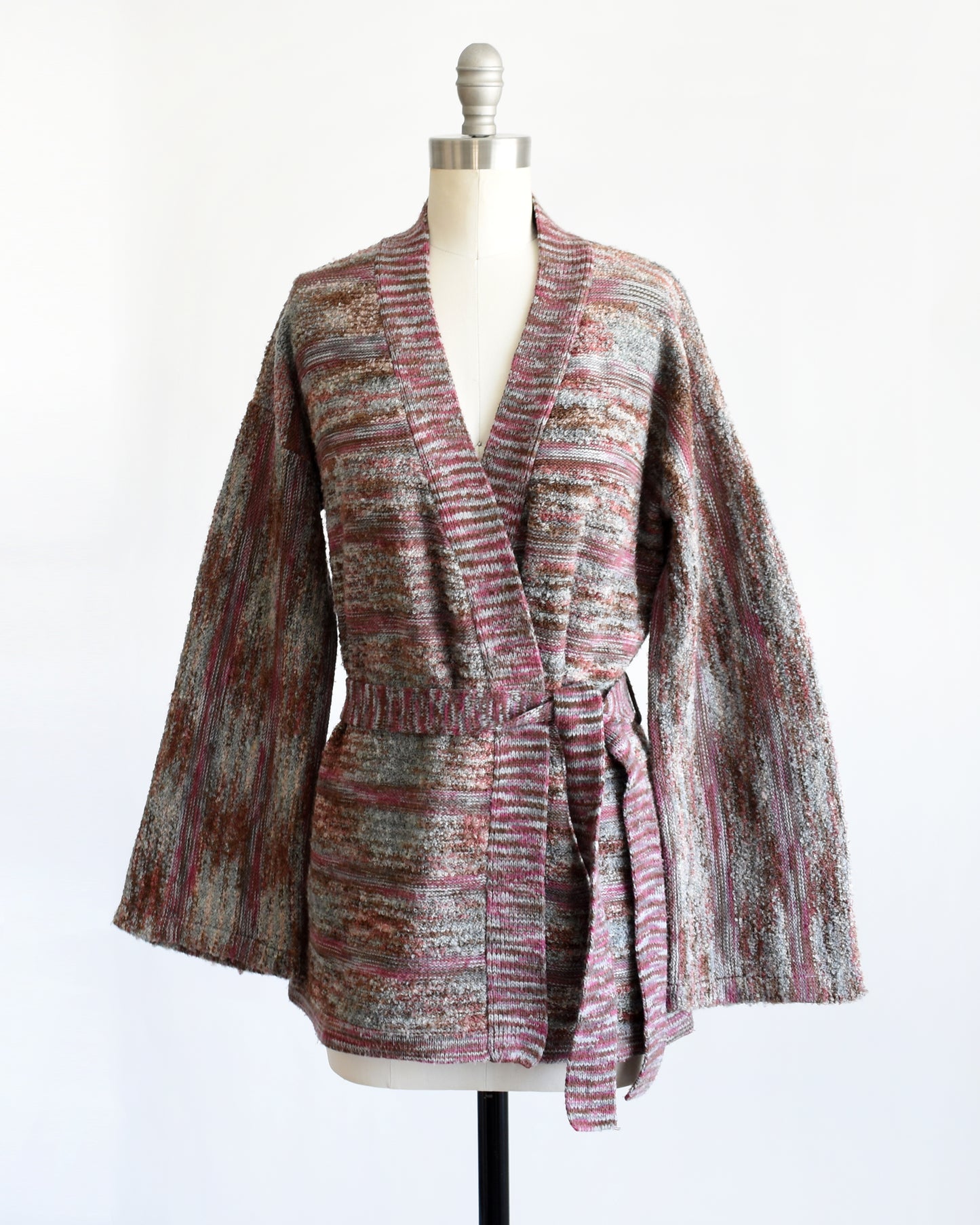 side front view of a vintage 1970s space dye wrap cardigan on a dress form against a white background