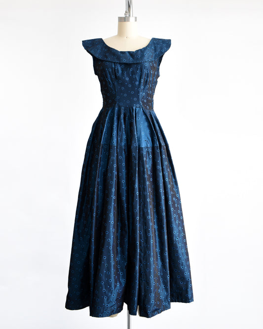 a vintage 1950s blue black floral brocade dress