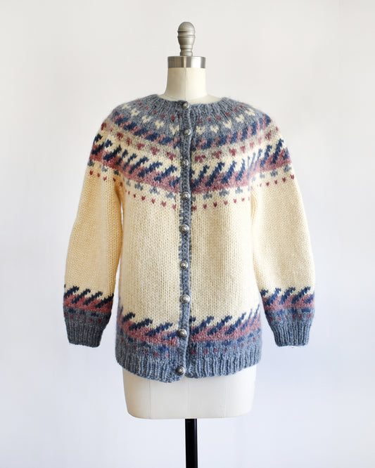 a vintage 1970s Icelandic knitted sweater with a pattern on a mannequin against a white background