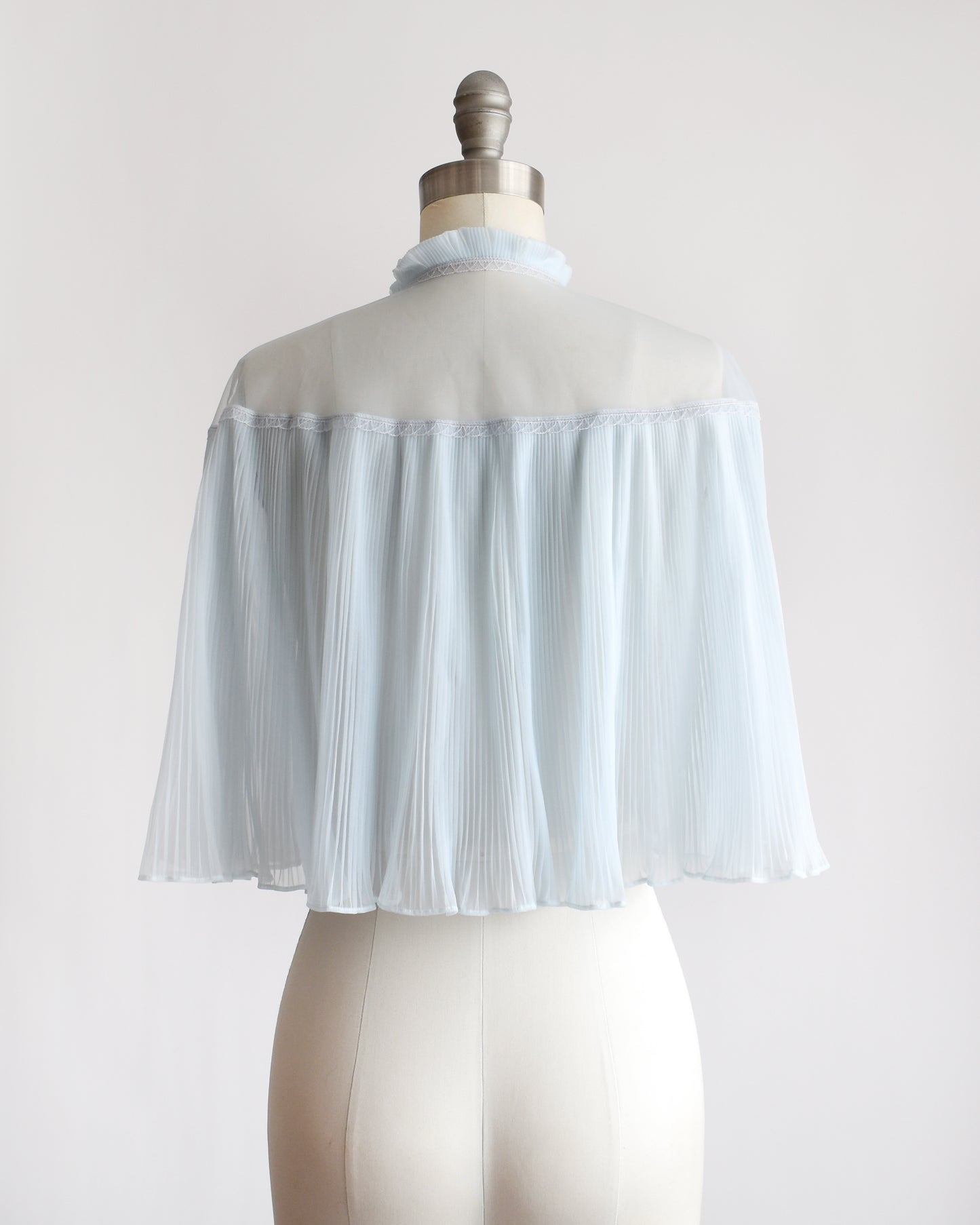 back view of a vintage 1960s light blue pleated bed jacket