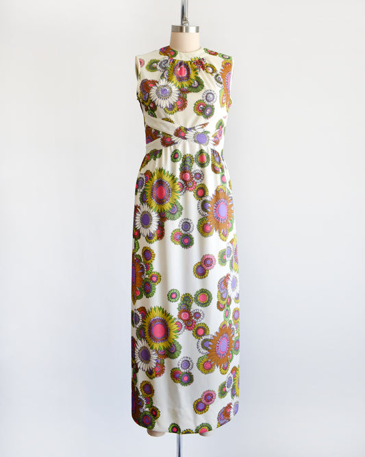 a vintage 1970s colorful floral dress on a mannequin against a white background