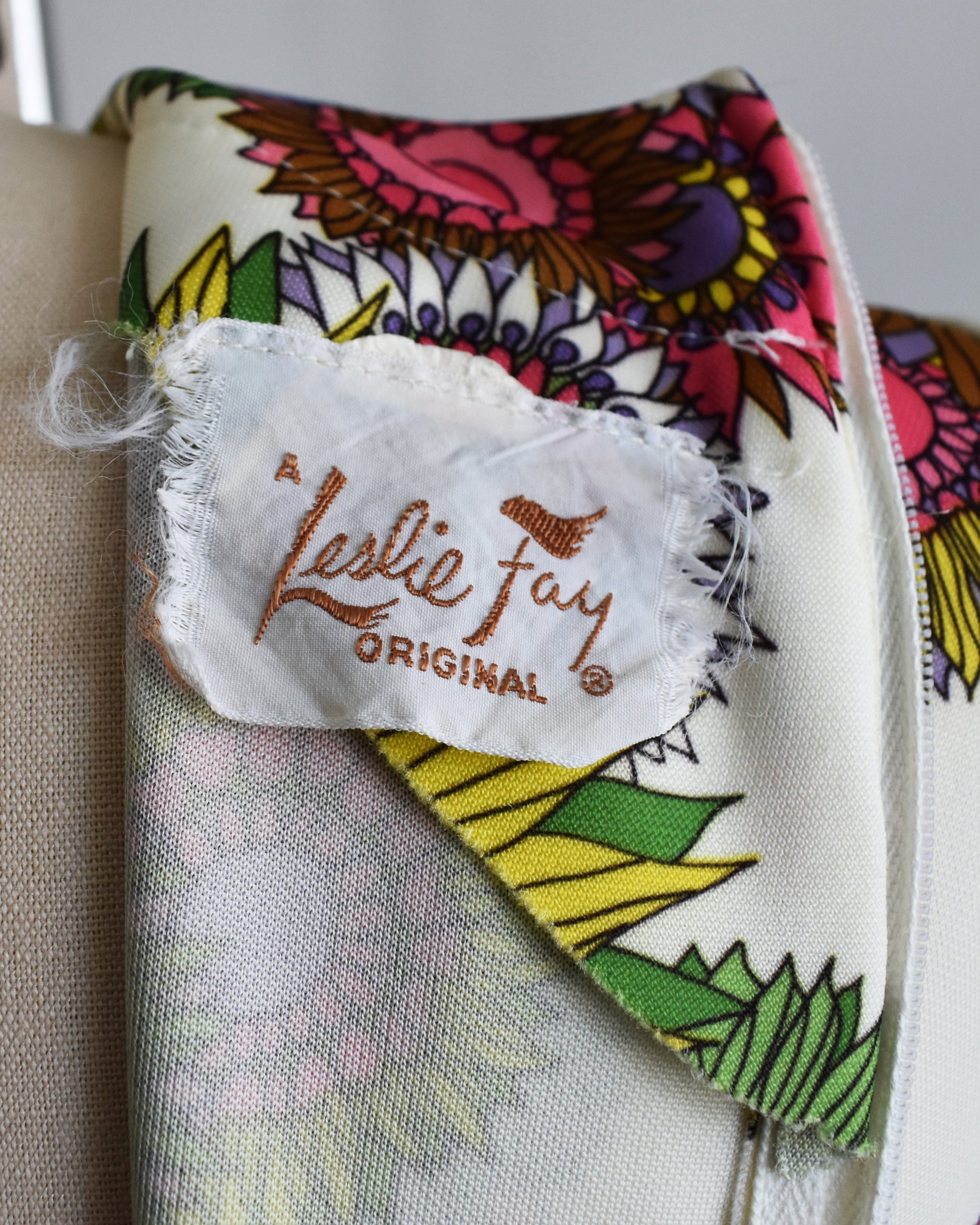 Colorful fabric with a 'Leslie Fay Original' label on a neutral background