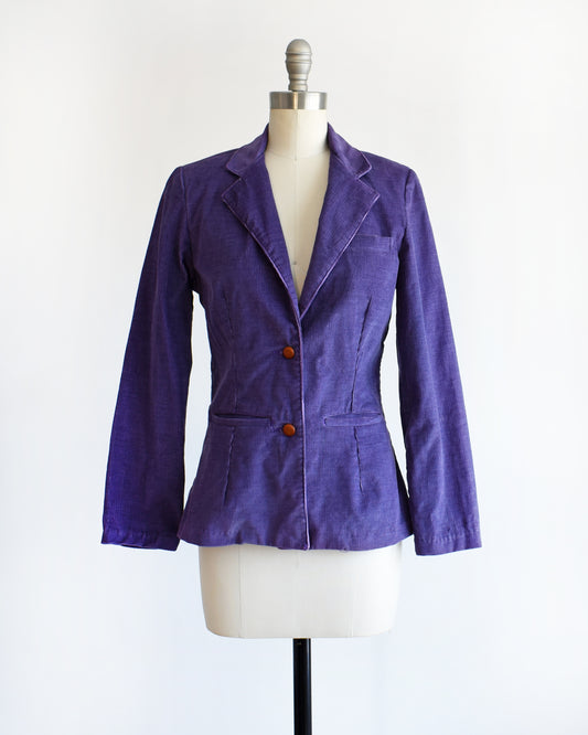 a vintage 1970s purple blazer on a mannequin against a white background