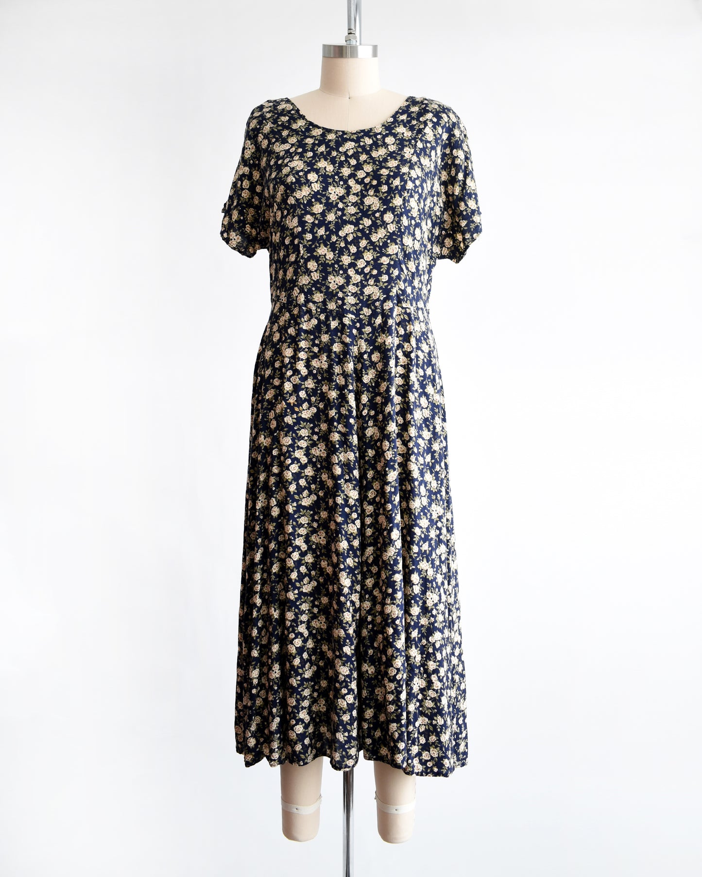 a vintage 1990s floral dress on a mannequin against a white background