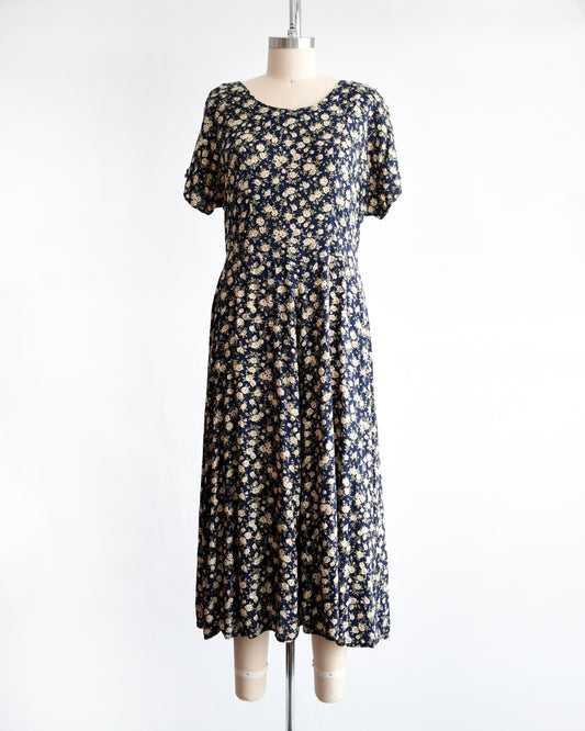 a vintage 1990s floral dress on a mannequin against a white background