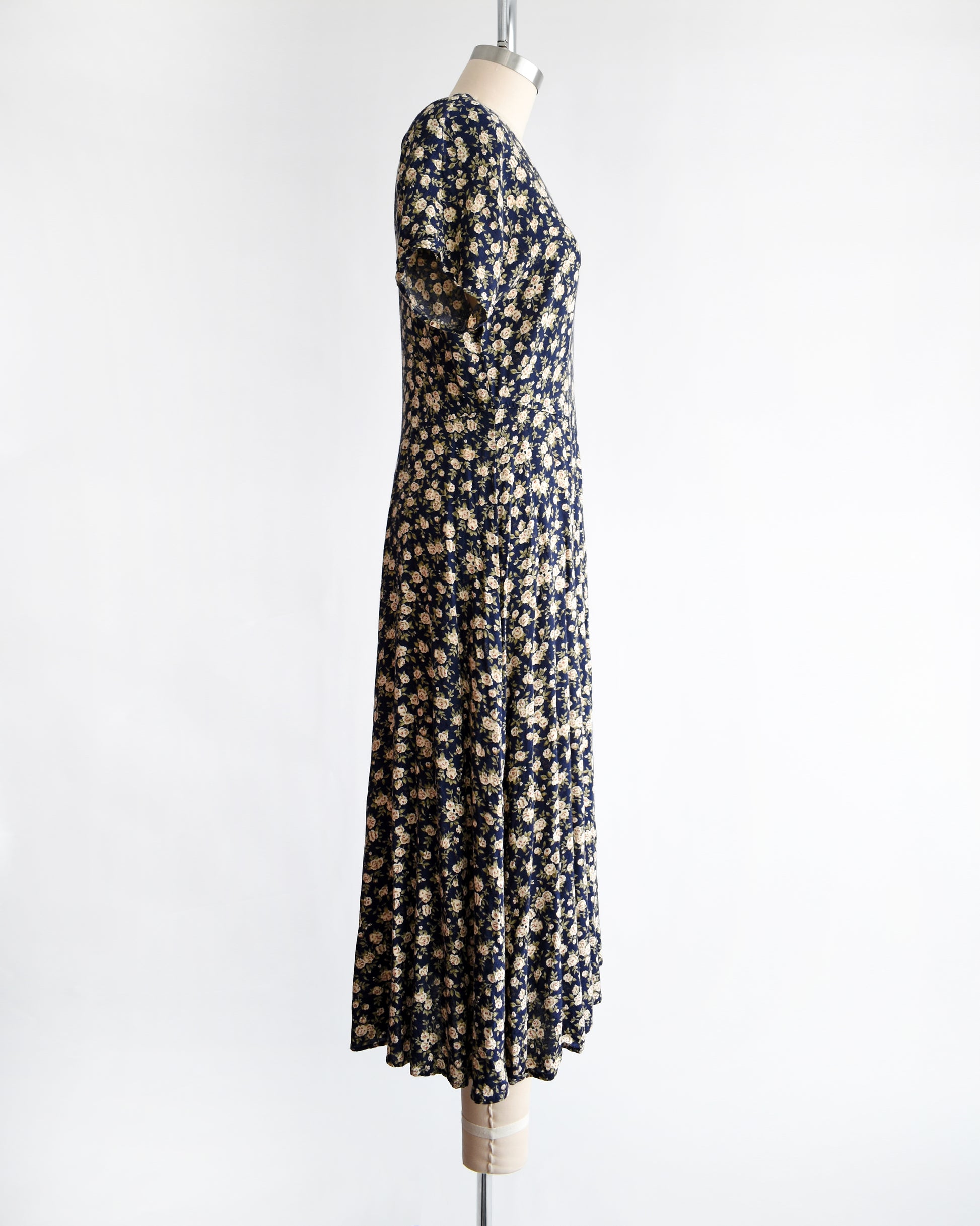 side view of a vintage 1990s floral dress on a mannequin against a white background