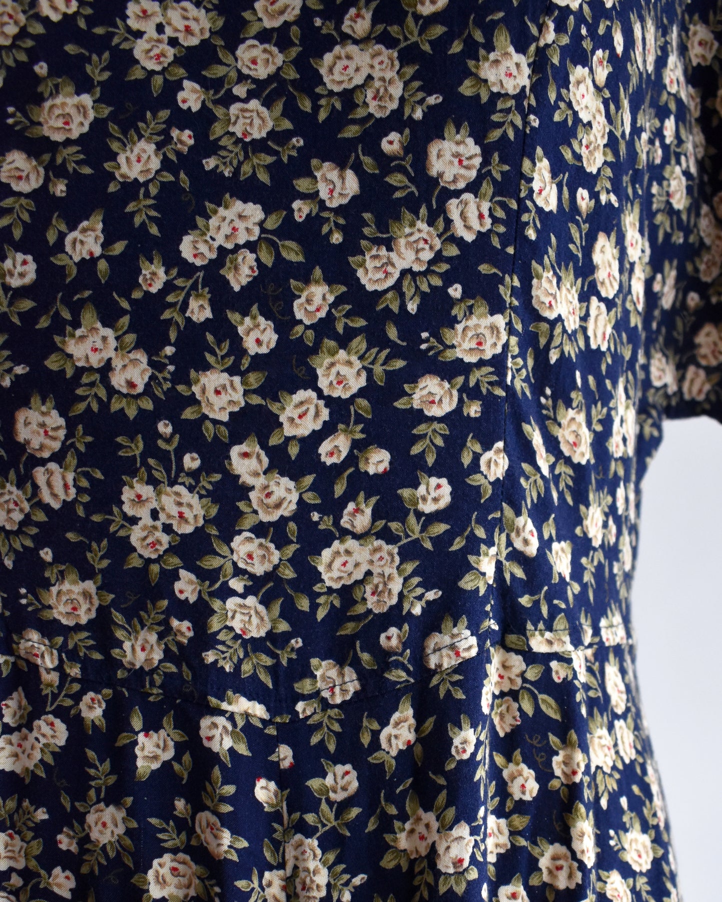 close up of a vintage 1990s floral dress on a mannequin against a white background