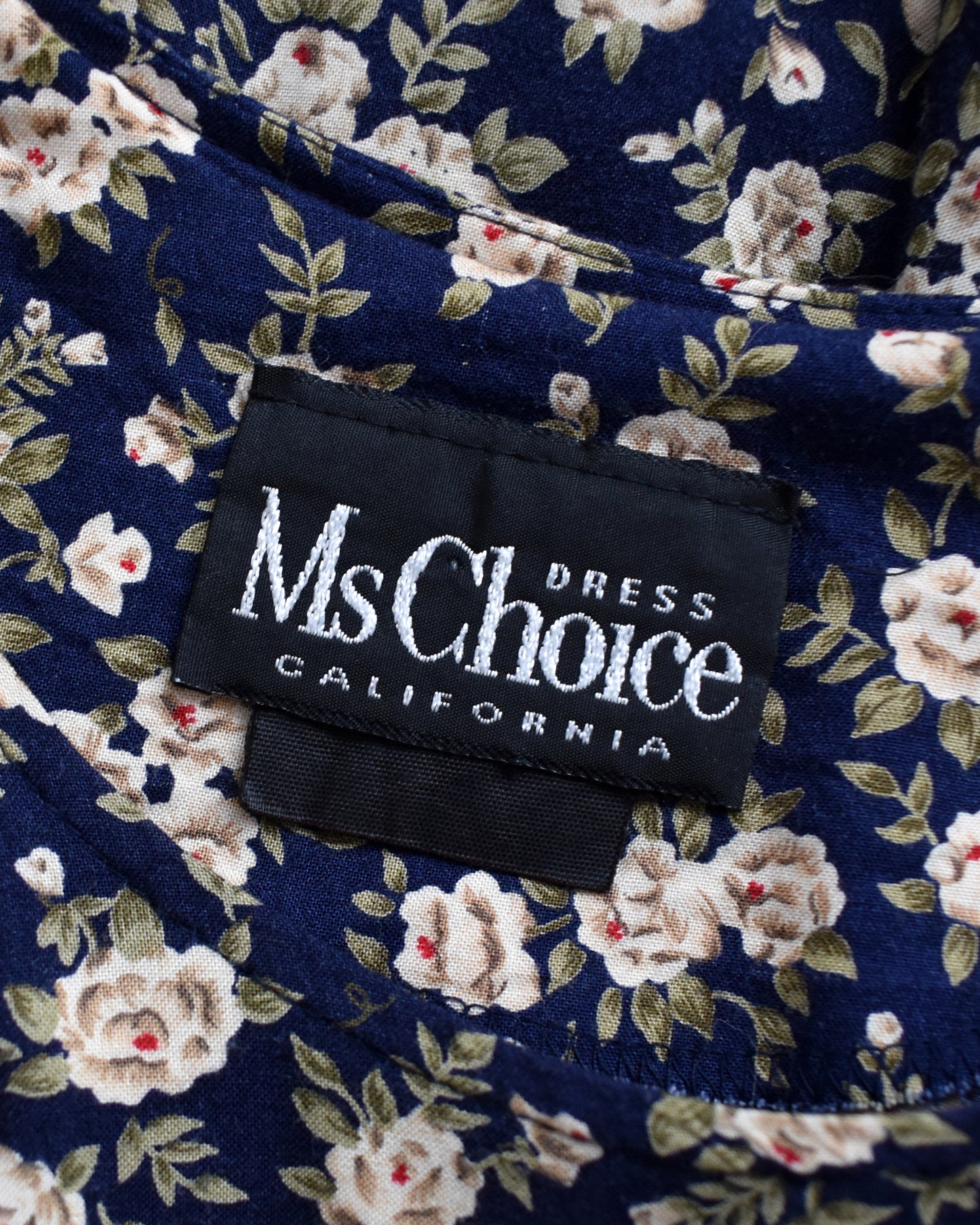 Floral dress label with 'Ms Choice California' text on a navy background
