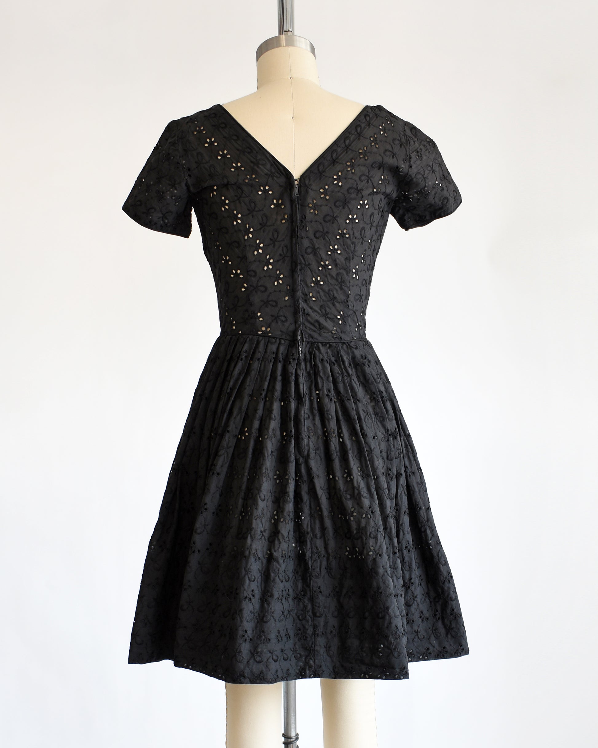 back view of a late 1950s early 1960s vintage black eyelet dress