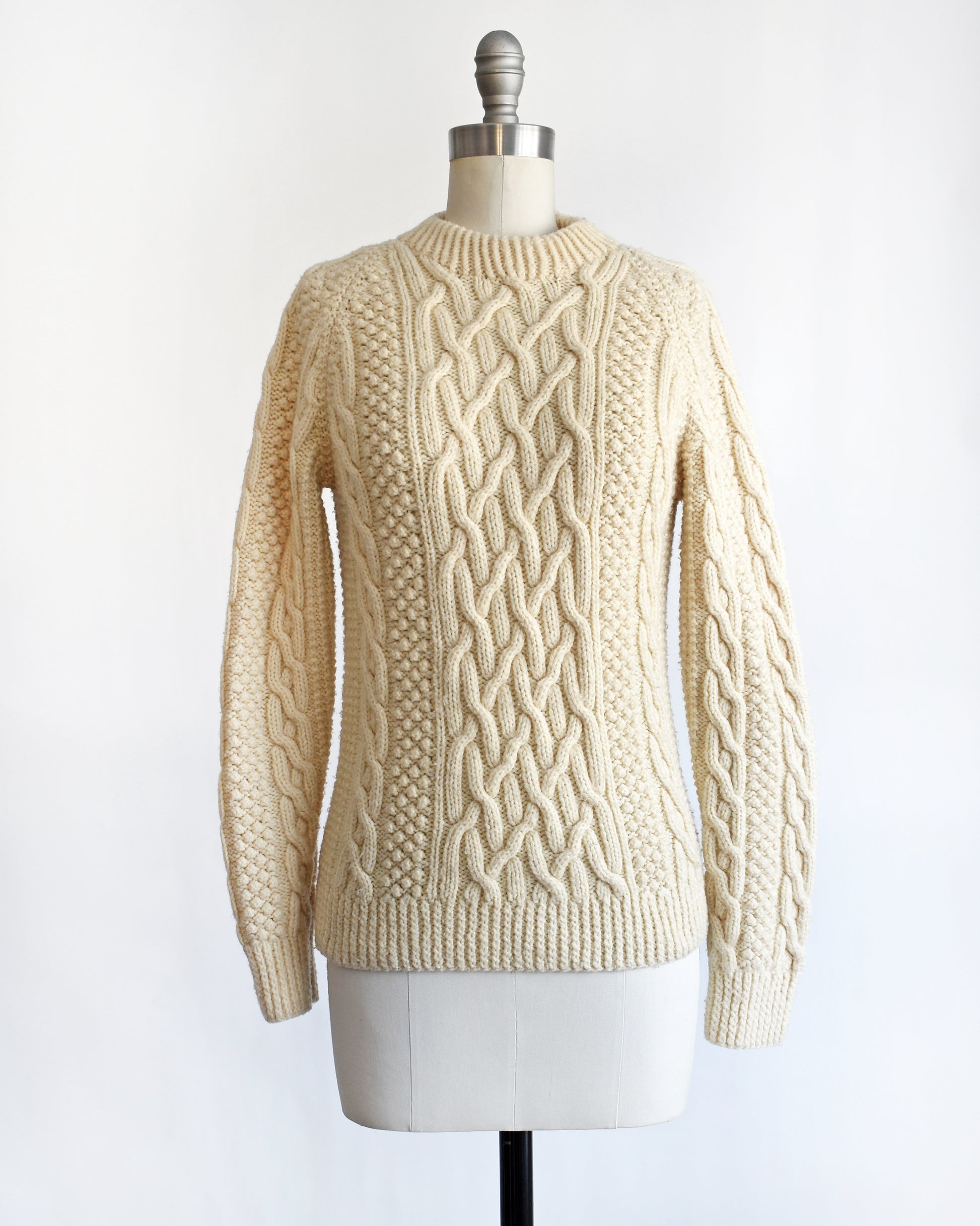 a vintage 1970s cream wool cable knit sweater