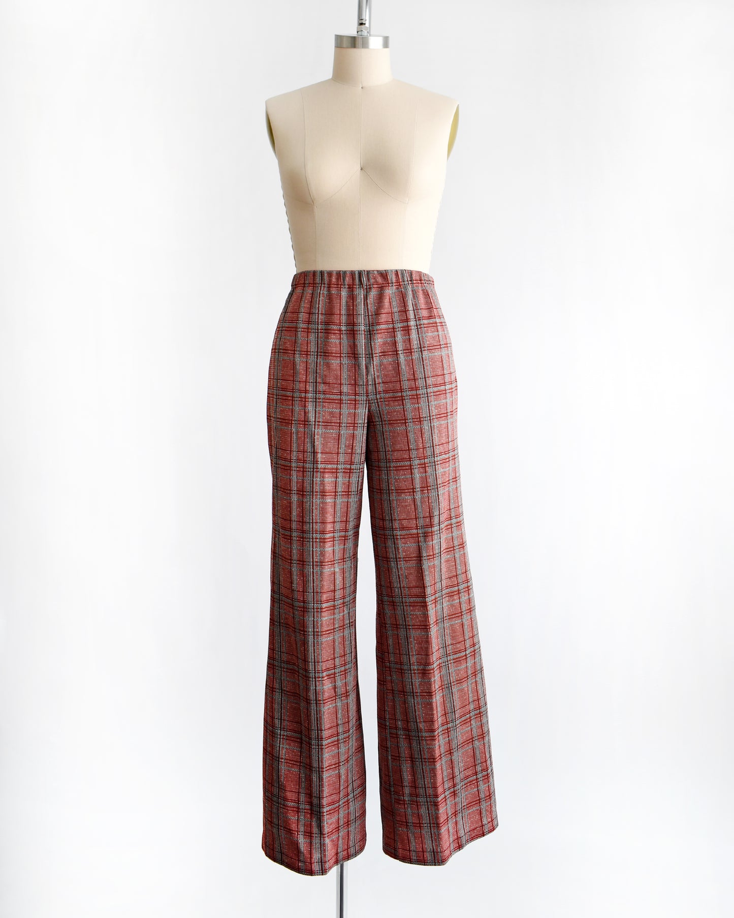 vintage 1970s red plaid pants on a mannequin against a white background