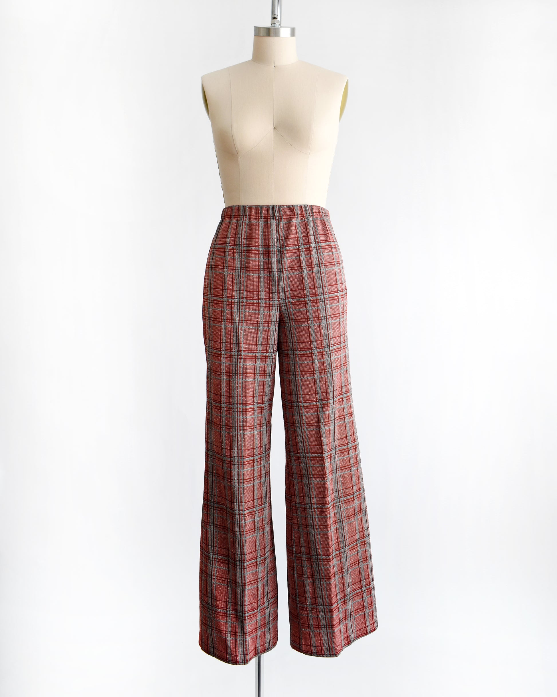 vintage 1970s red plaid pants on a mannequin against a white background