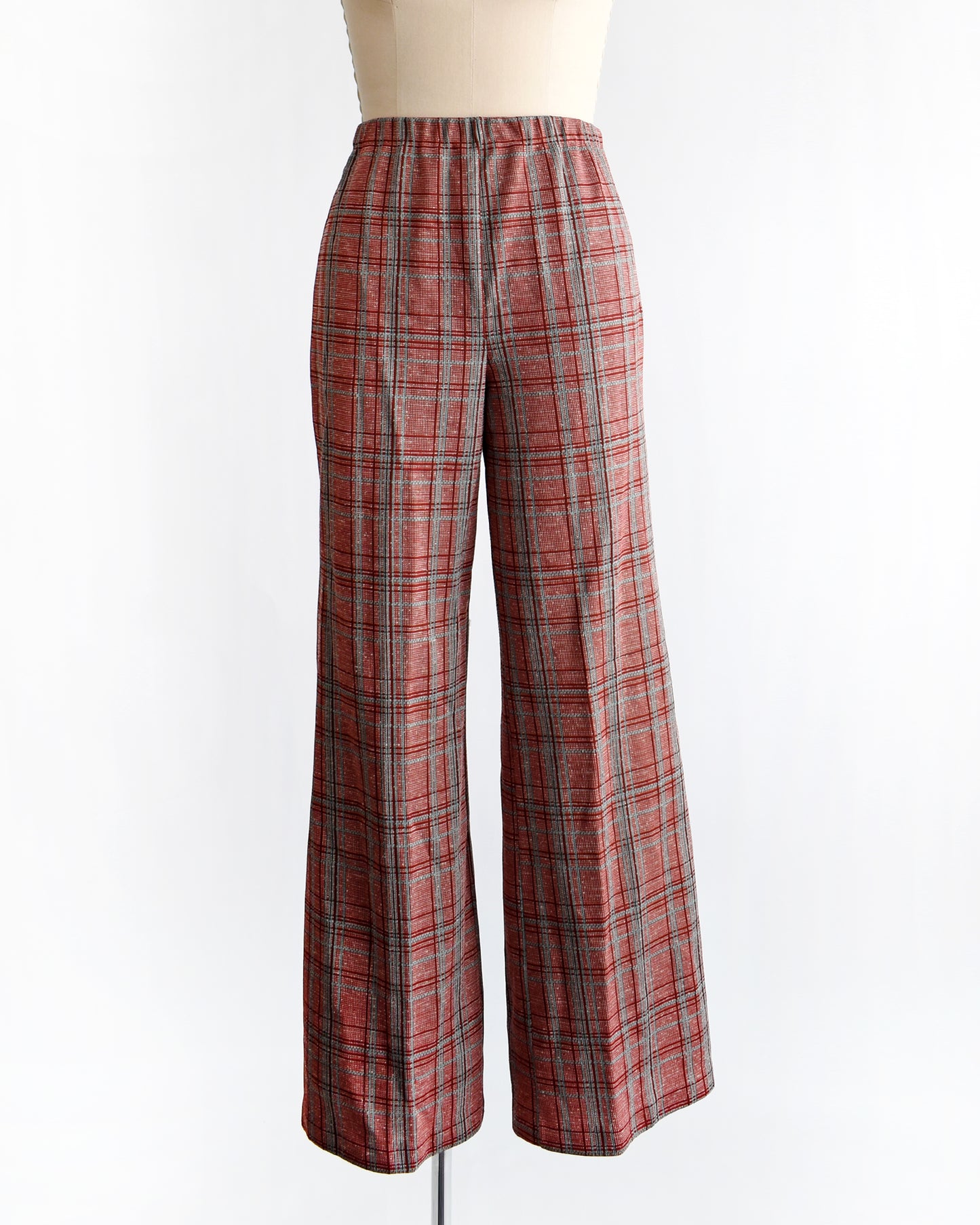 vintage 1970s red plaid pants on a mannequin against a white background