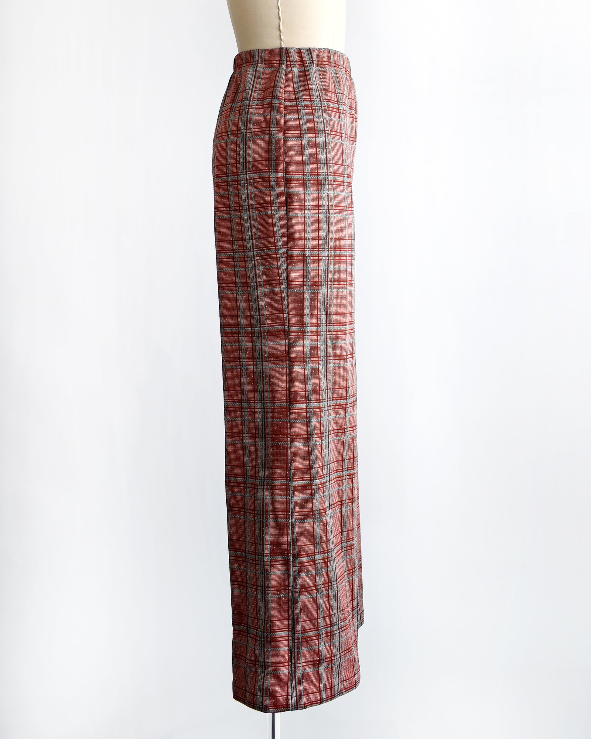 side view of vintage 1970s red plaid pants on a mannequin against a white background