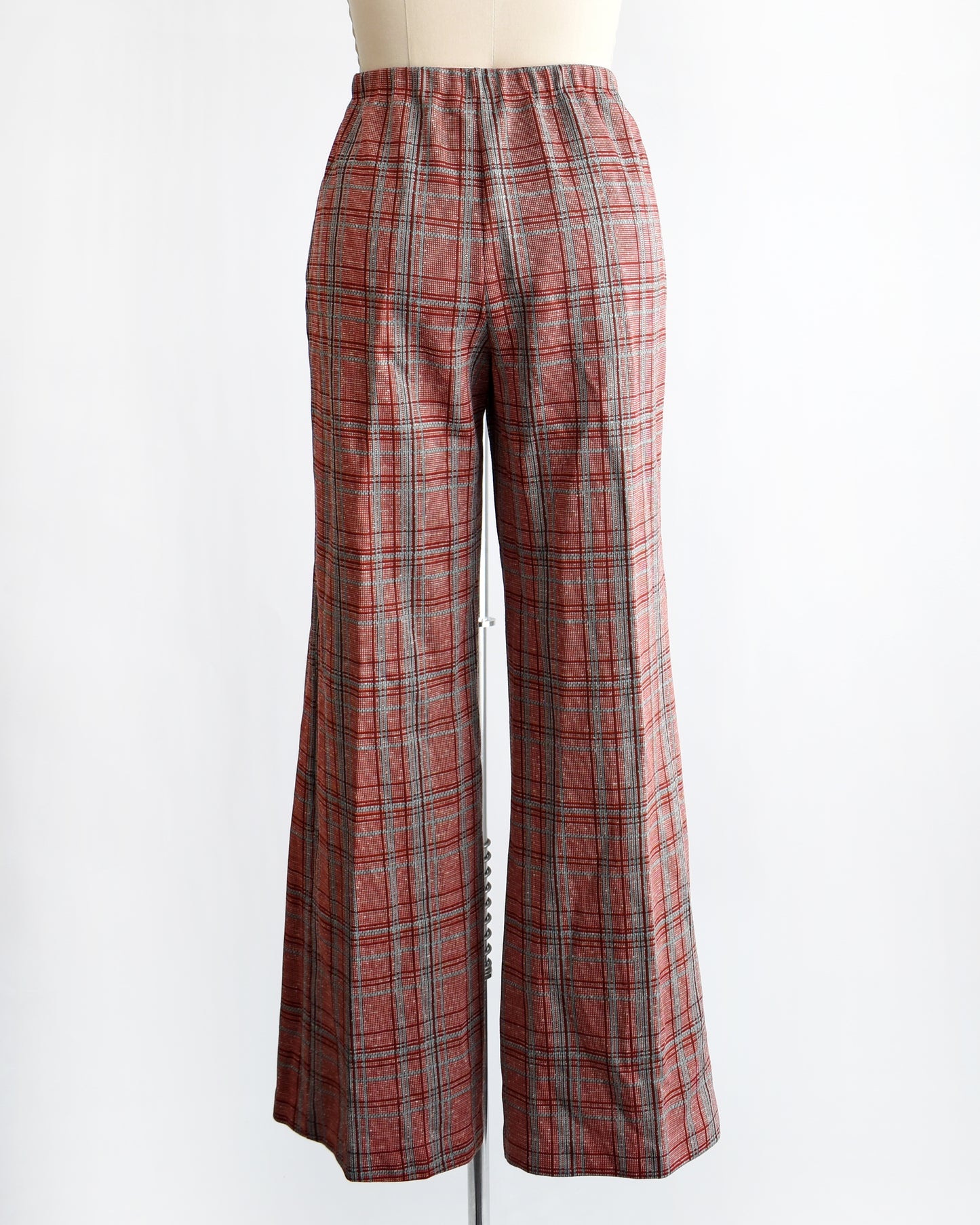 back view of vintage 1970s red plaid pants on a mannequin against a white background