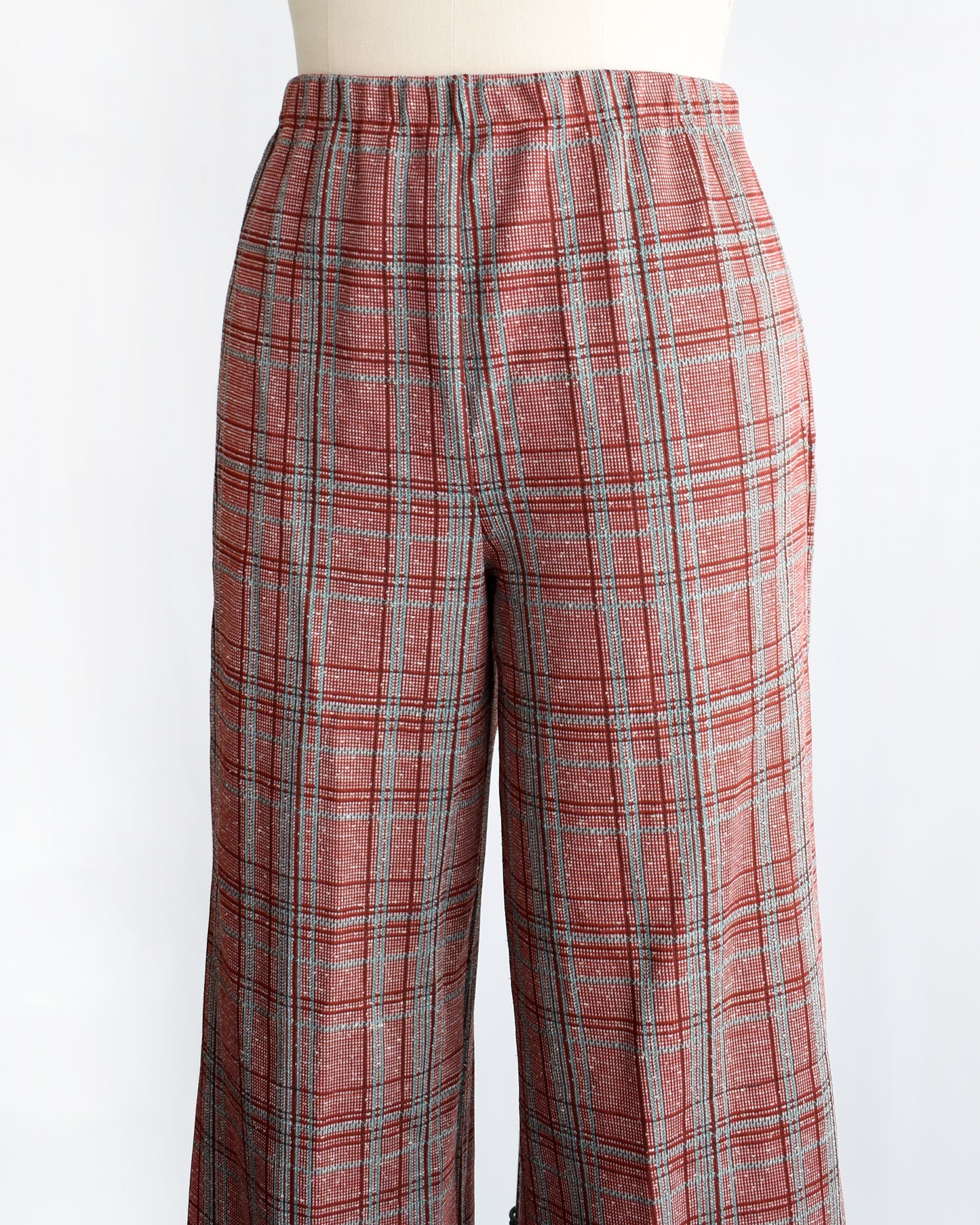 side front view of vintage 1970s red plaid pants on a mannequin against a white background