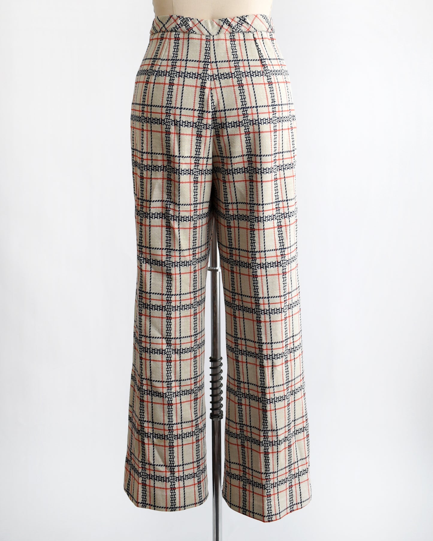 back view of vintage 1970s plaid pants on a mannequin against a white background