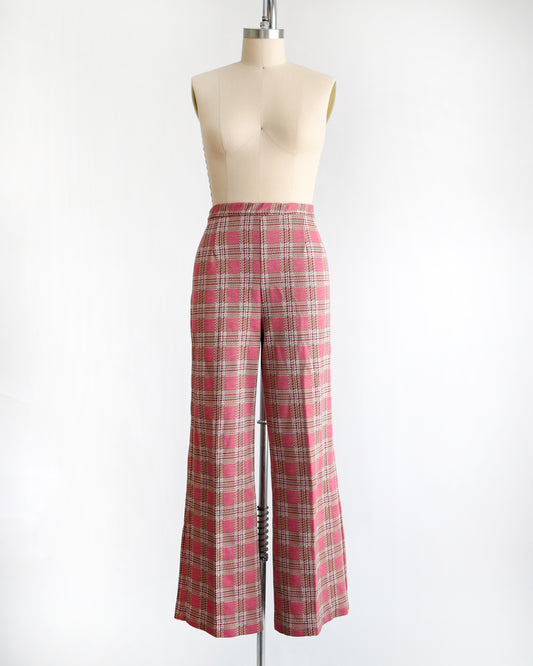 vintage 1970s pink plaid pants on a mannequin against a white background
