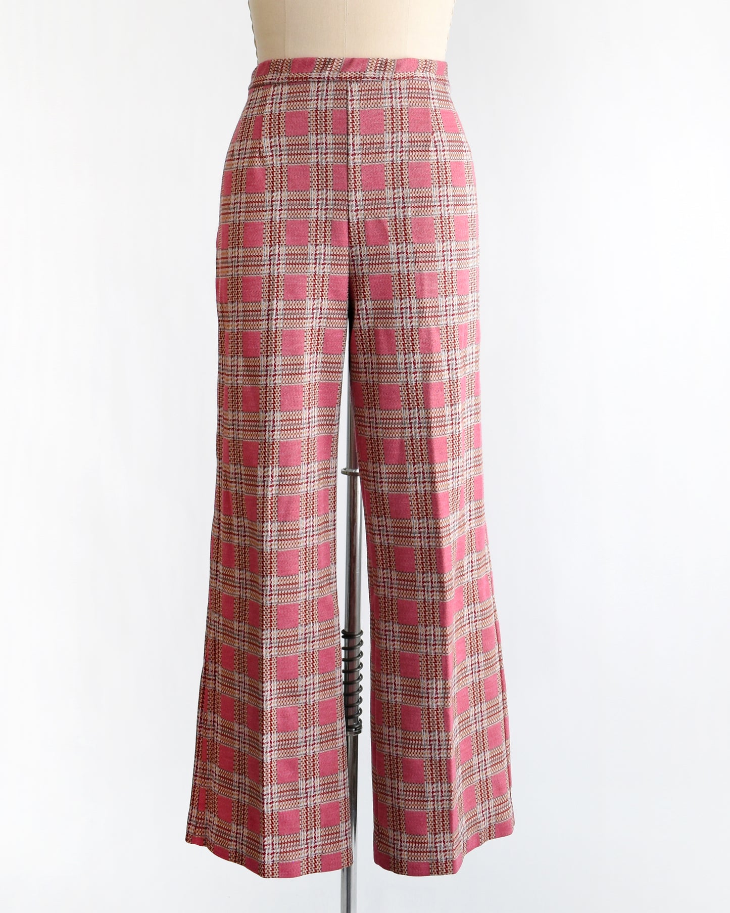 vintage 1970s pink plaid pants on a mannequin against a white background
