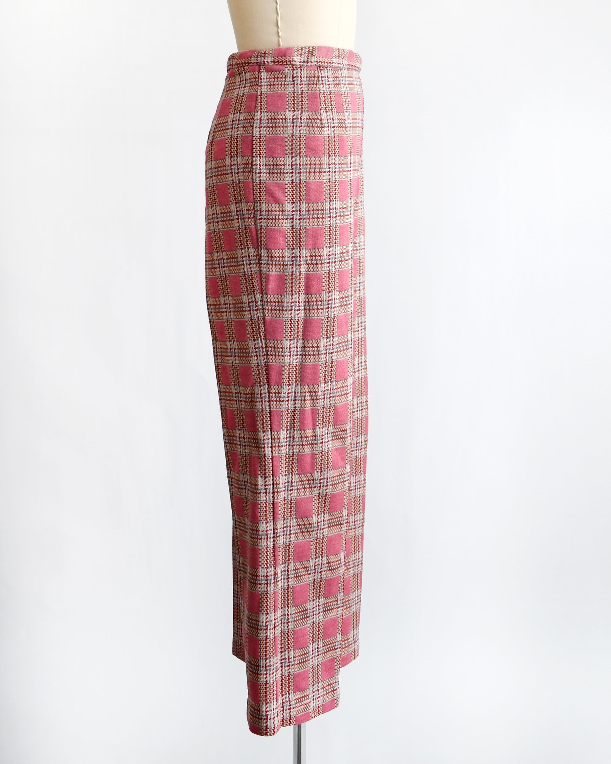 side view of vintage 1970s pink plaid pants on a mannequin against a white background