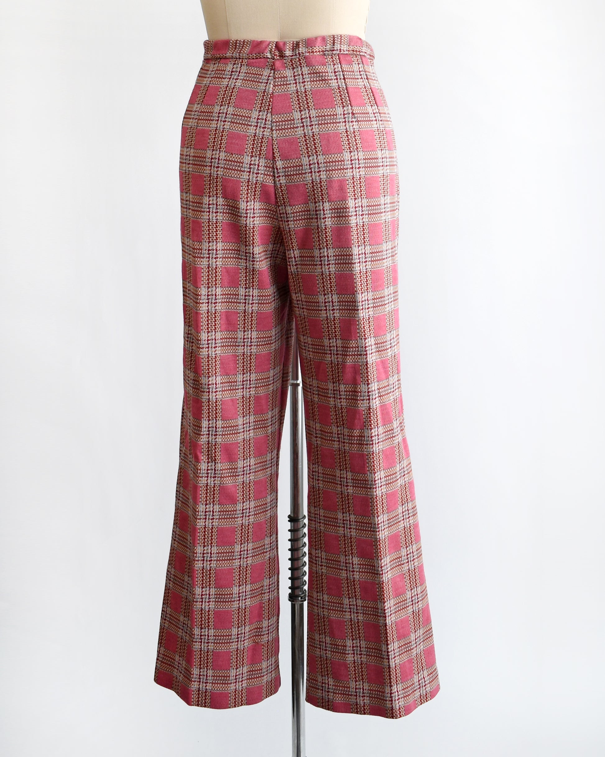 back view of vintage 1970s pink plaid pants on a mannequin against a white background