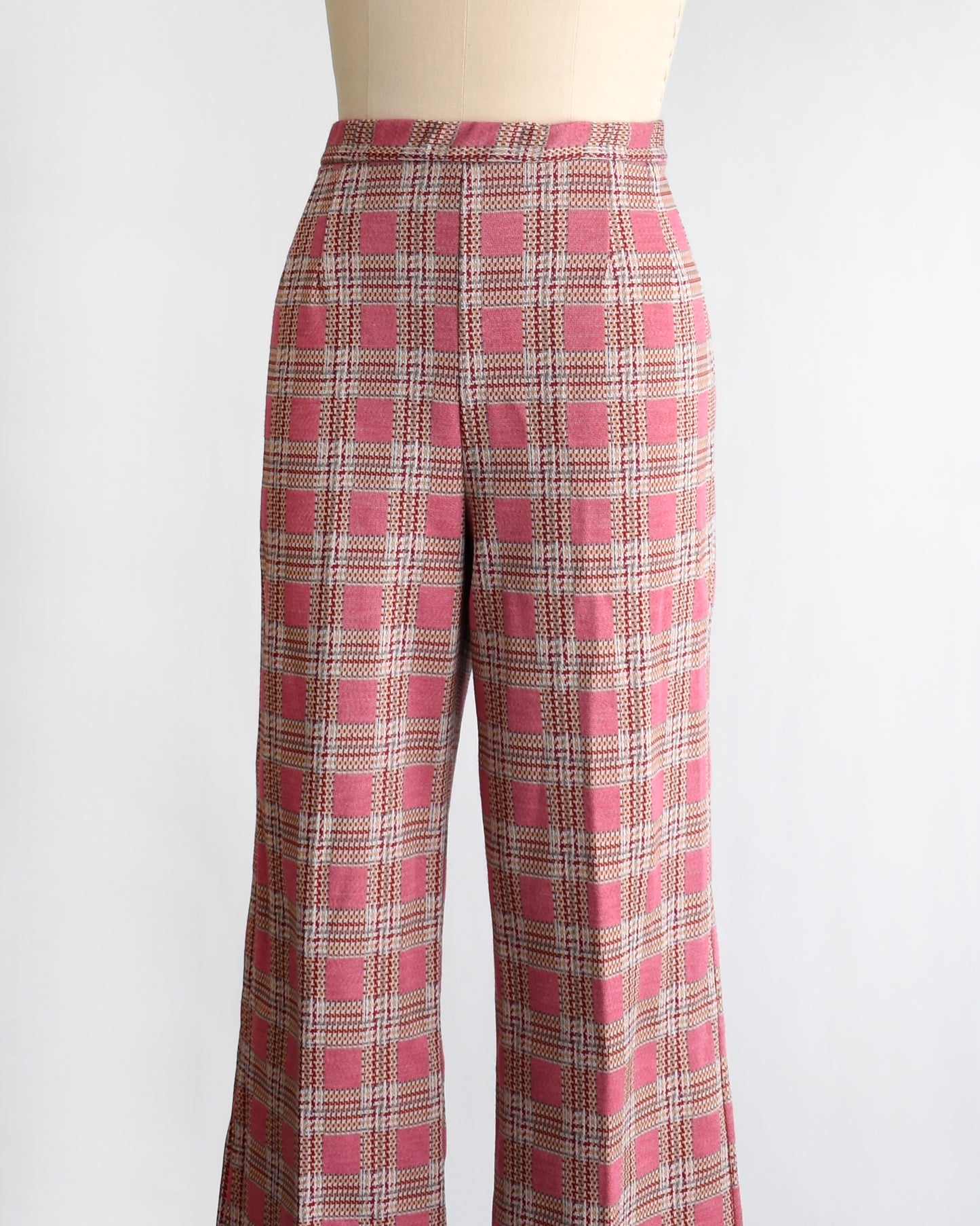 side front view of vintage 1970s pink plaid pants on a mannequin against a white background