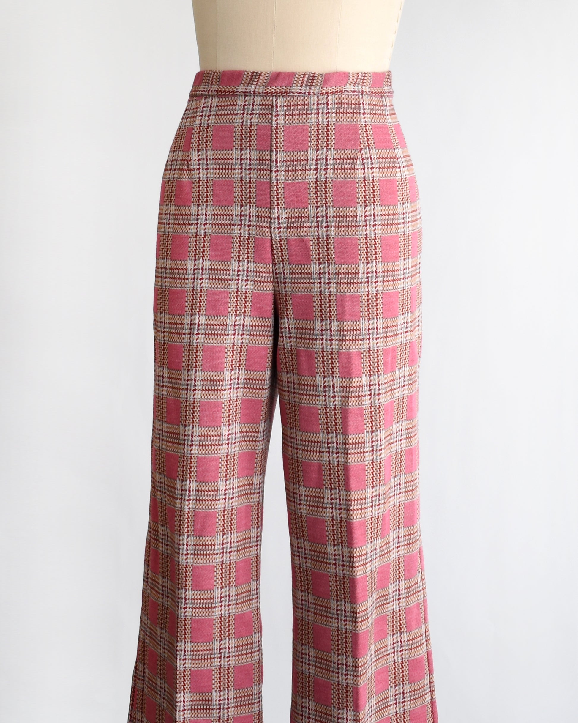 side front view of vintage 1970s pink plaid pants on a mannequin against a white background