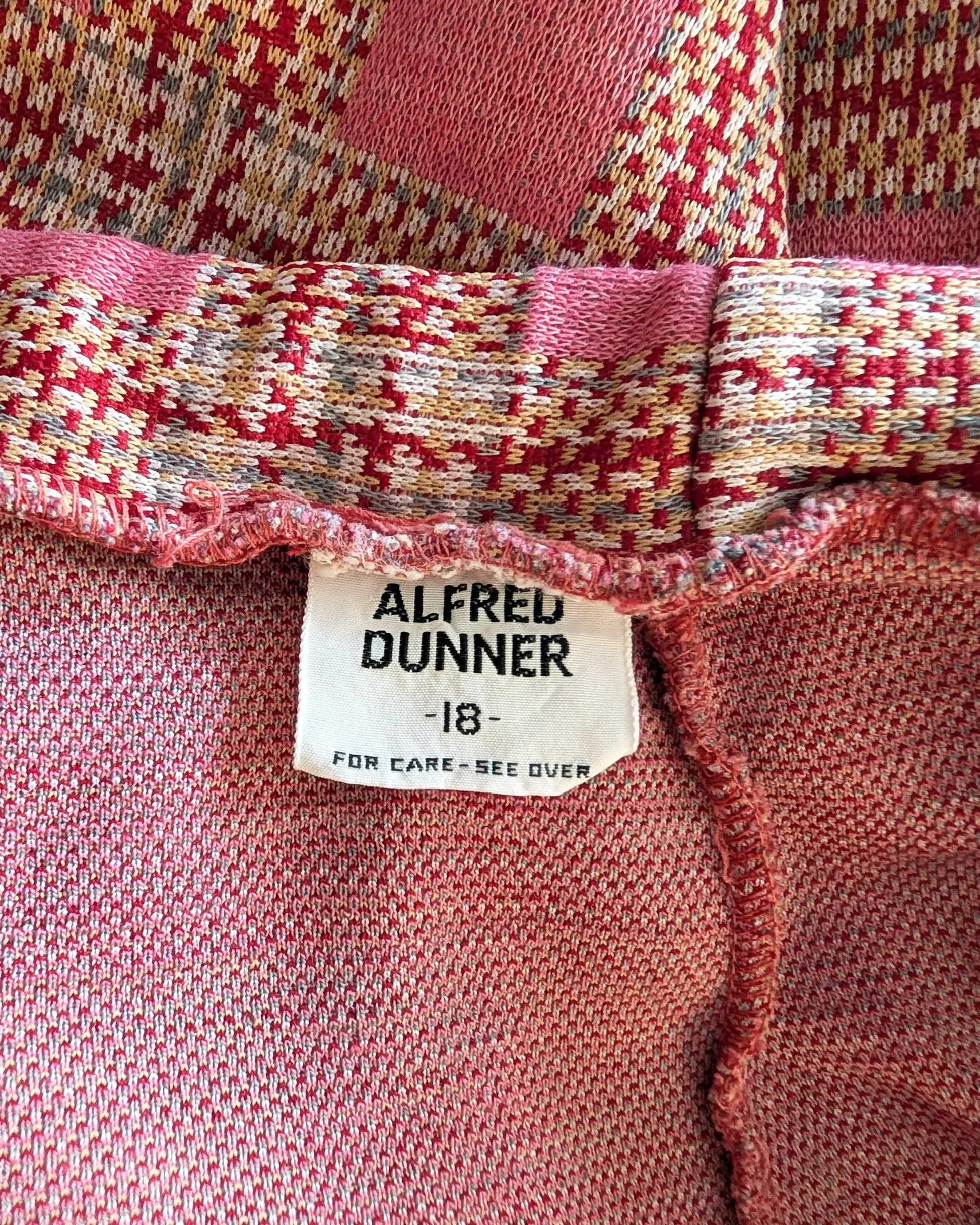 Close-up of a red textured fabric with an Alfred Dunner label.