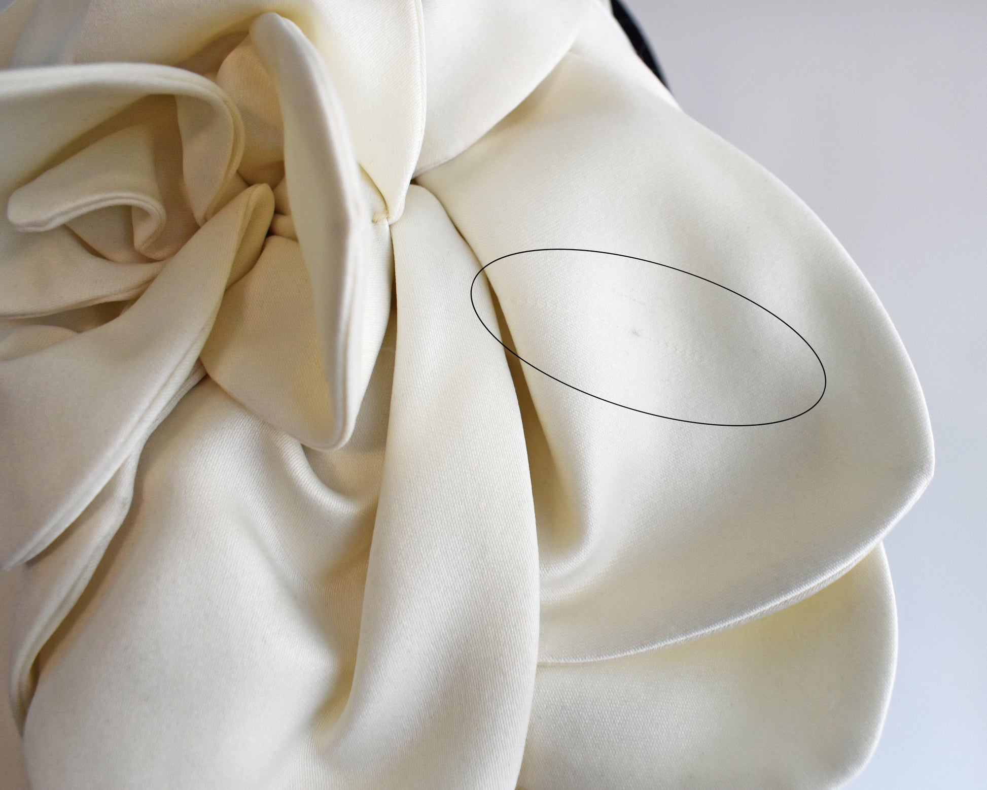 close up of a small run in the fabric of one of the floral sleeves