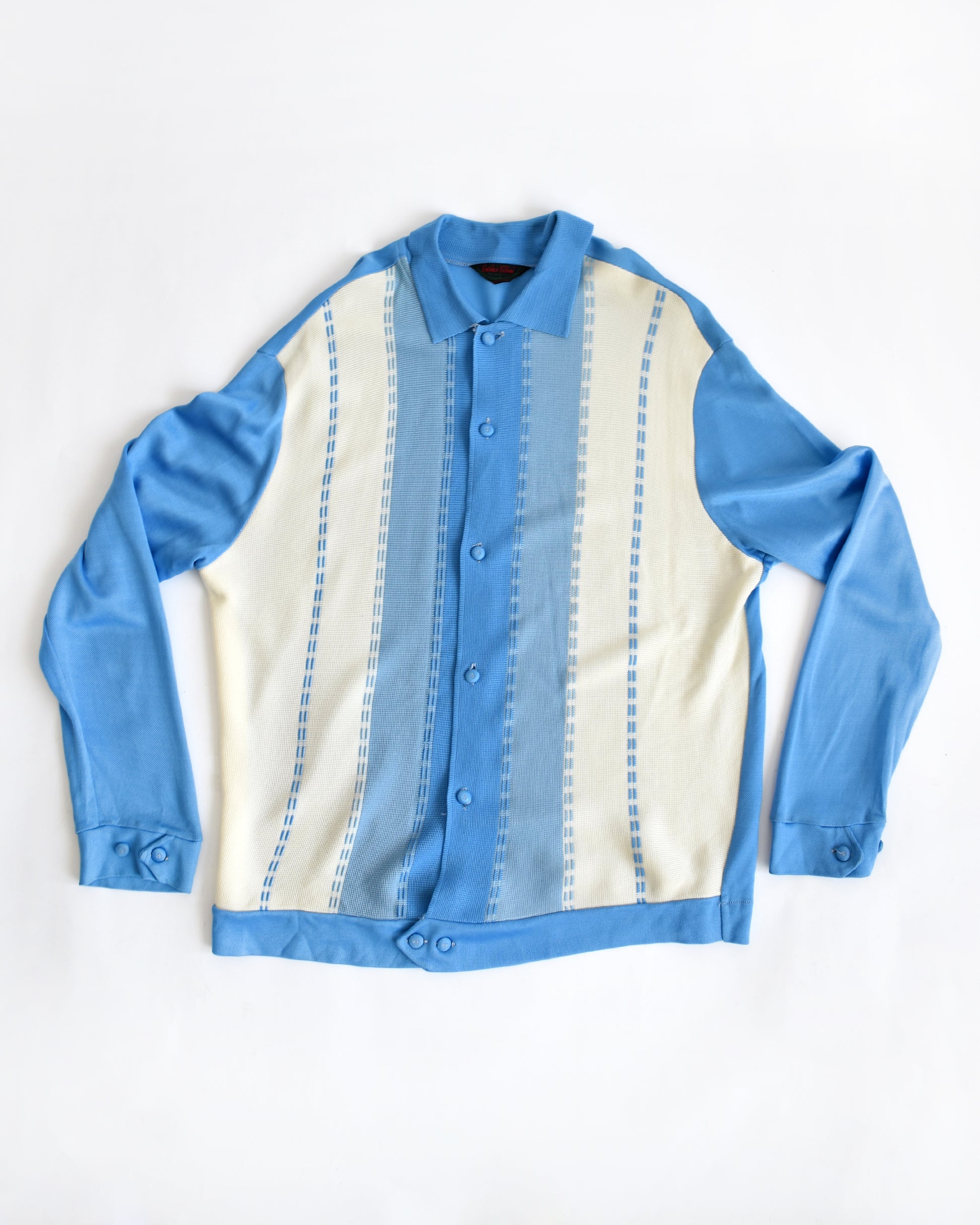 a vintage 1960s/1970s blue and white striped cardigan on a white background