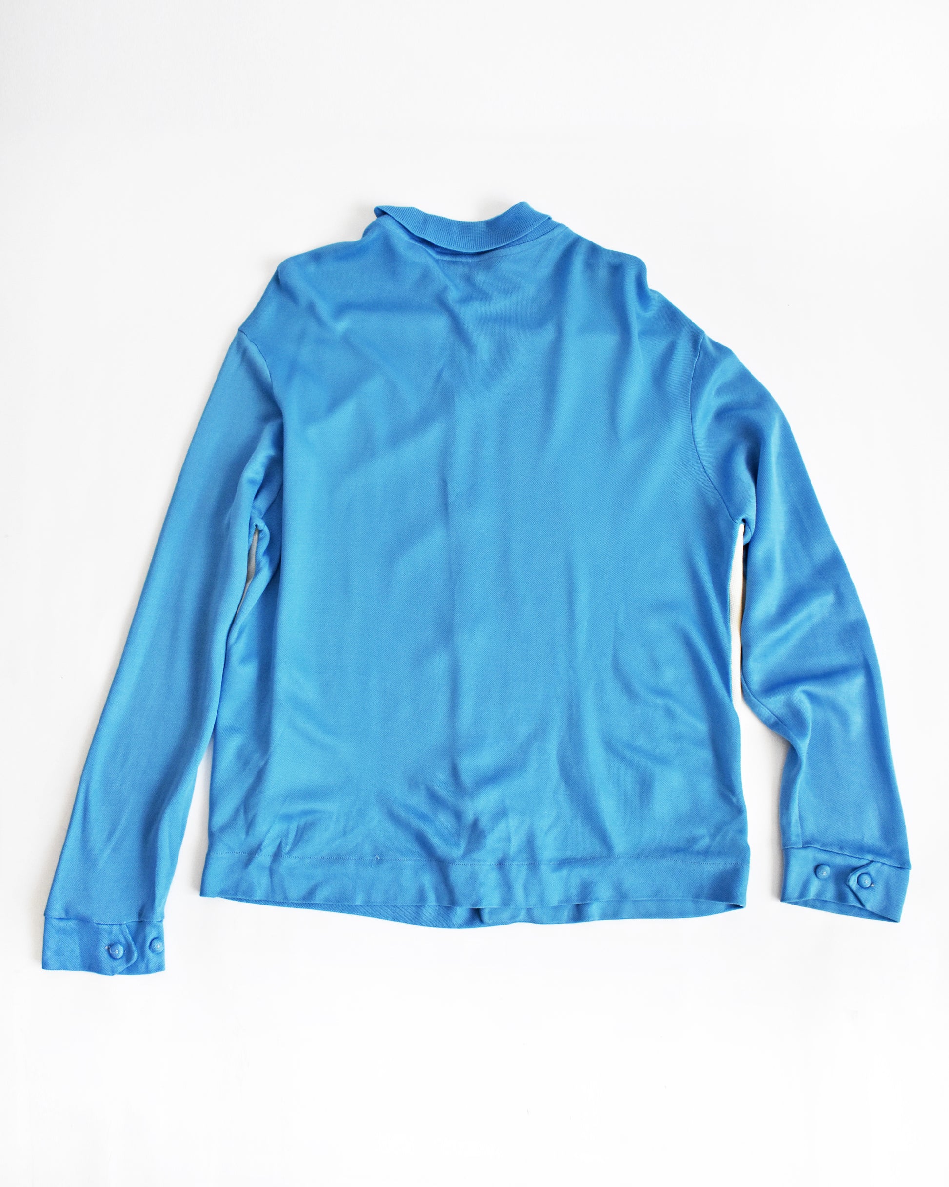 back view of a vintage 1960s/1970s blue and white striped cardigan on a white background