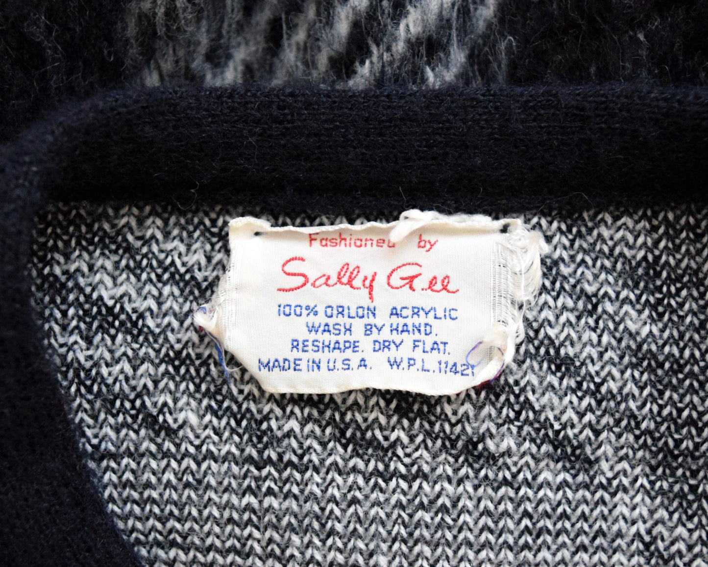 Close up of the tag which says Sally Gee