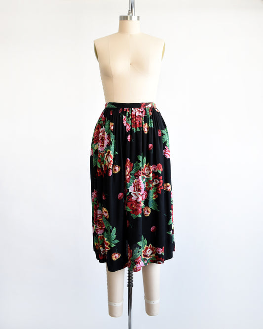 a vintage 1990s black floral skirt on a mannequin against a white background