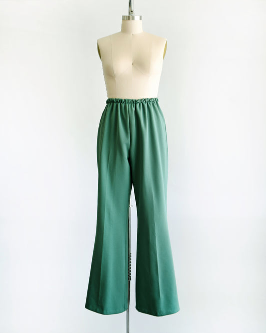 a pair of vintage 1970s green wide leg pants on a dress form