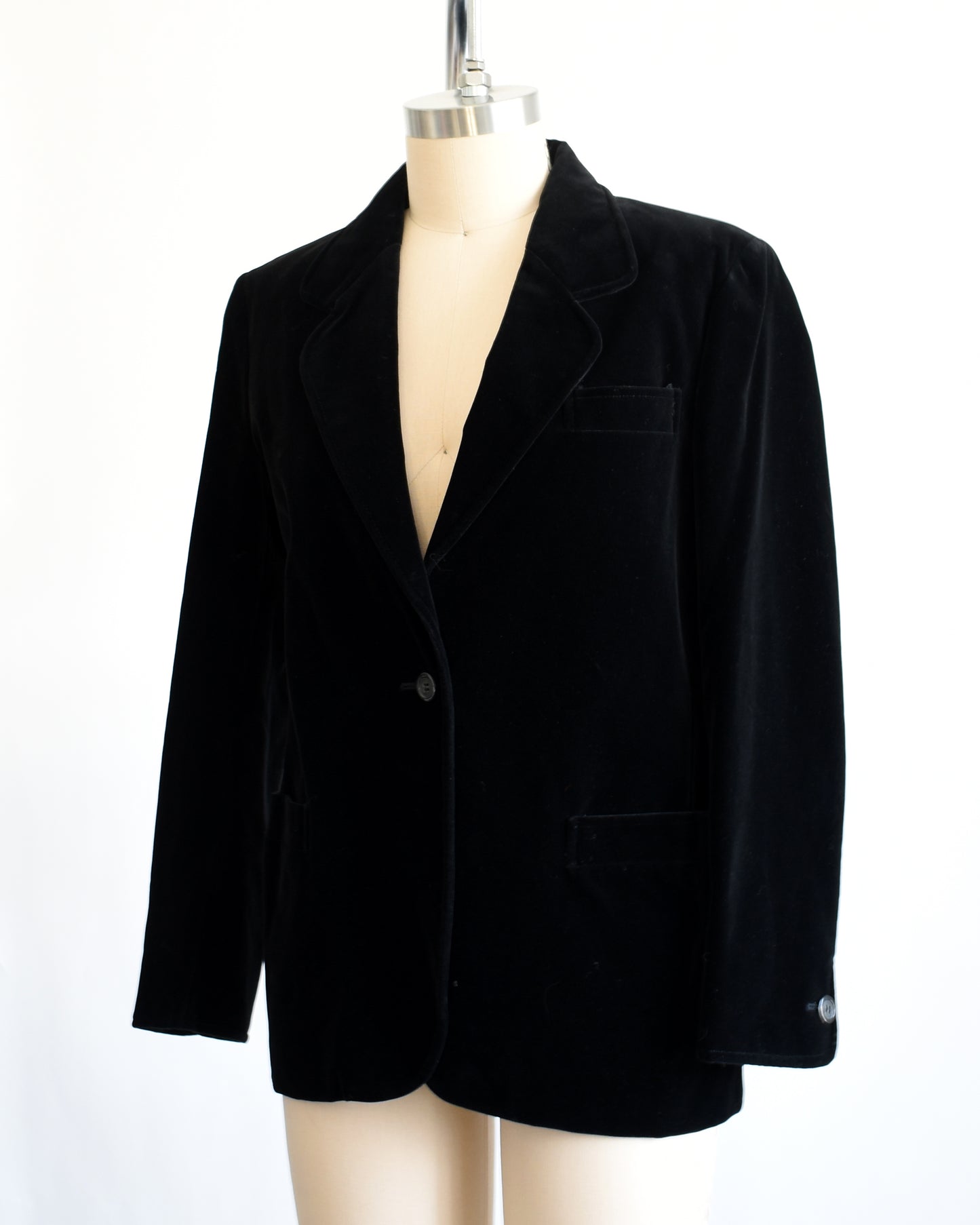 side front view of a vintage black blazer on a mannequin against a white background