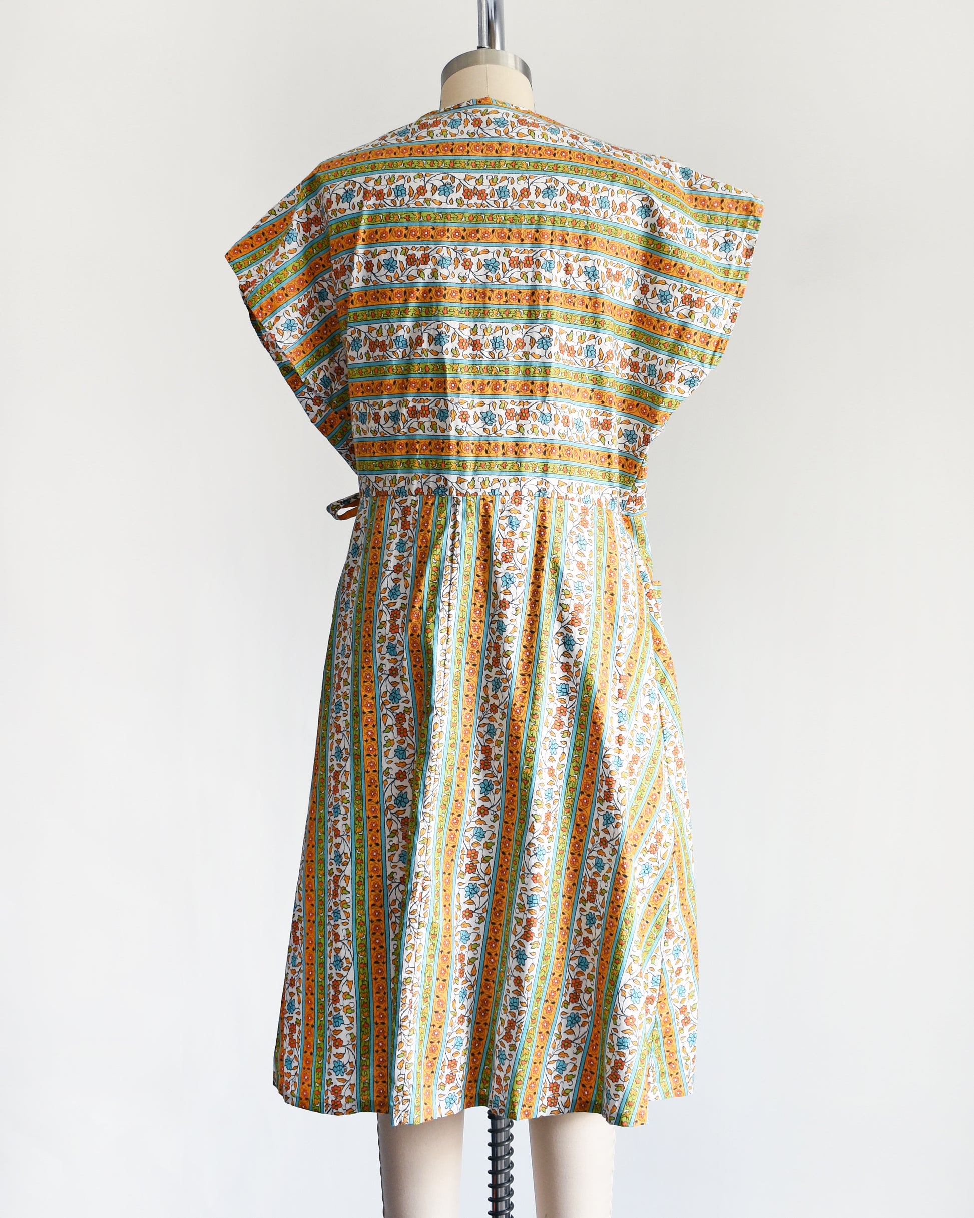 back view of a vintage striped floral vintage 1960s wrap house dress by Sandra Lee Frocks 