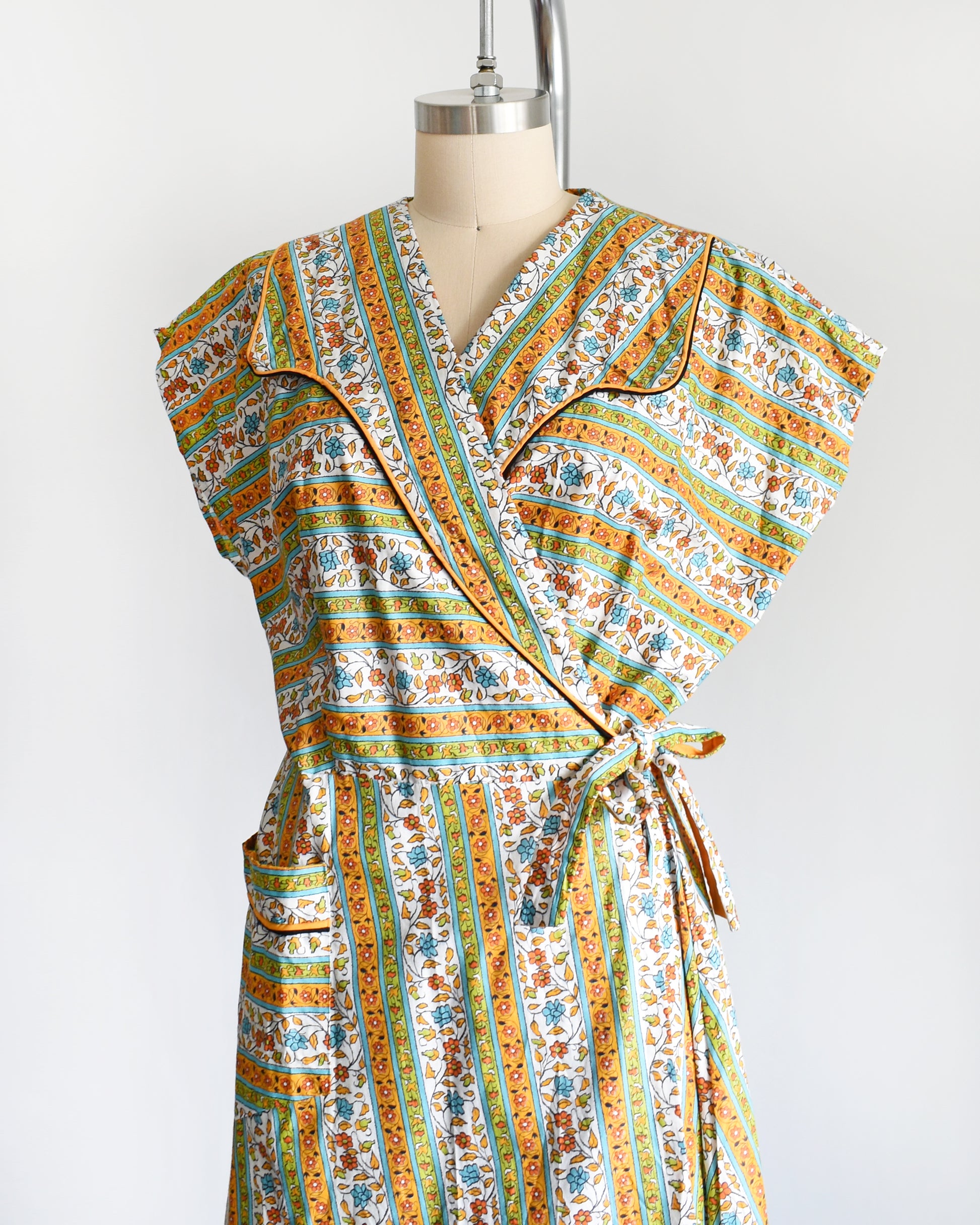 side front view of a vintage striped floral vintage 1960s wrap house dress by Sandra Lee Frocks 