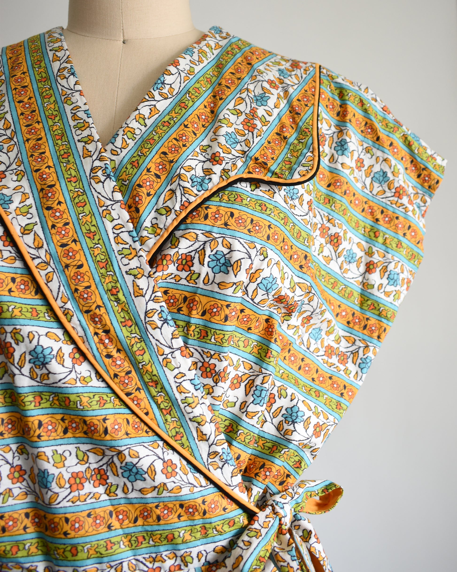 close up of the floral print on the bodice of a vintage striped floral vintage 1960s wrap house dress by Sandra Lee Frocks 