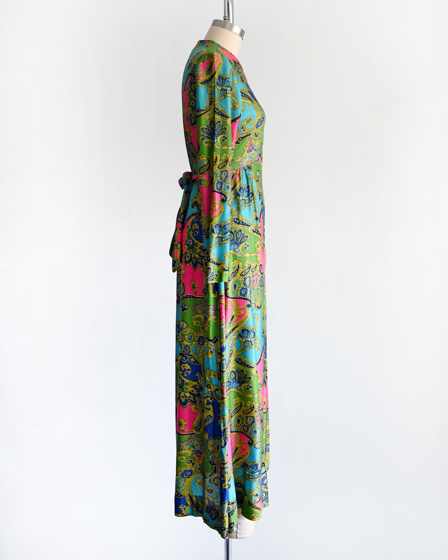 side view of a vintage late 1960s early 1970s psychedelic paisley print maxi dress