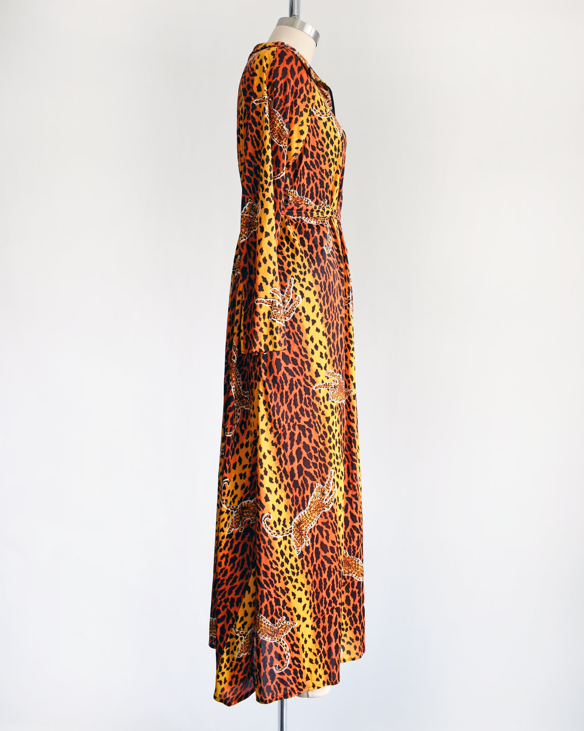 side view of a vintage 1970s leopard print long sleeve lounge dress with matching tie belt