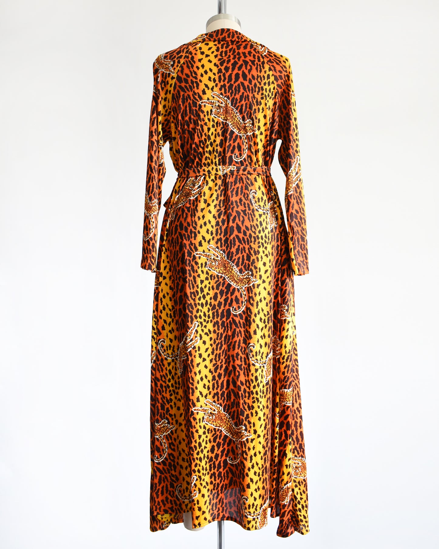 back view of a vintage 1970s leopard print long sleeve lounge dress with matching tie belt