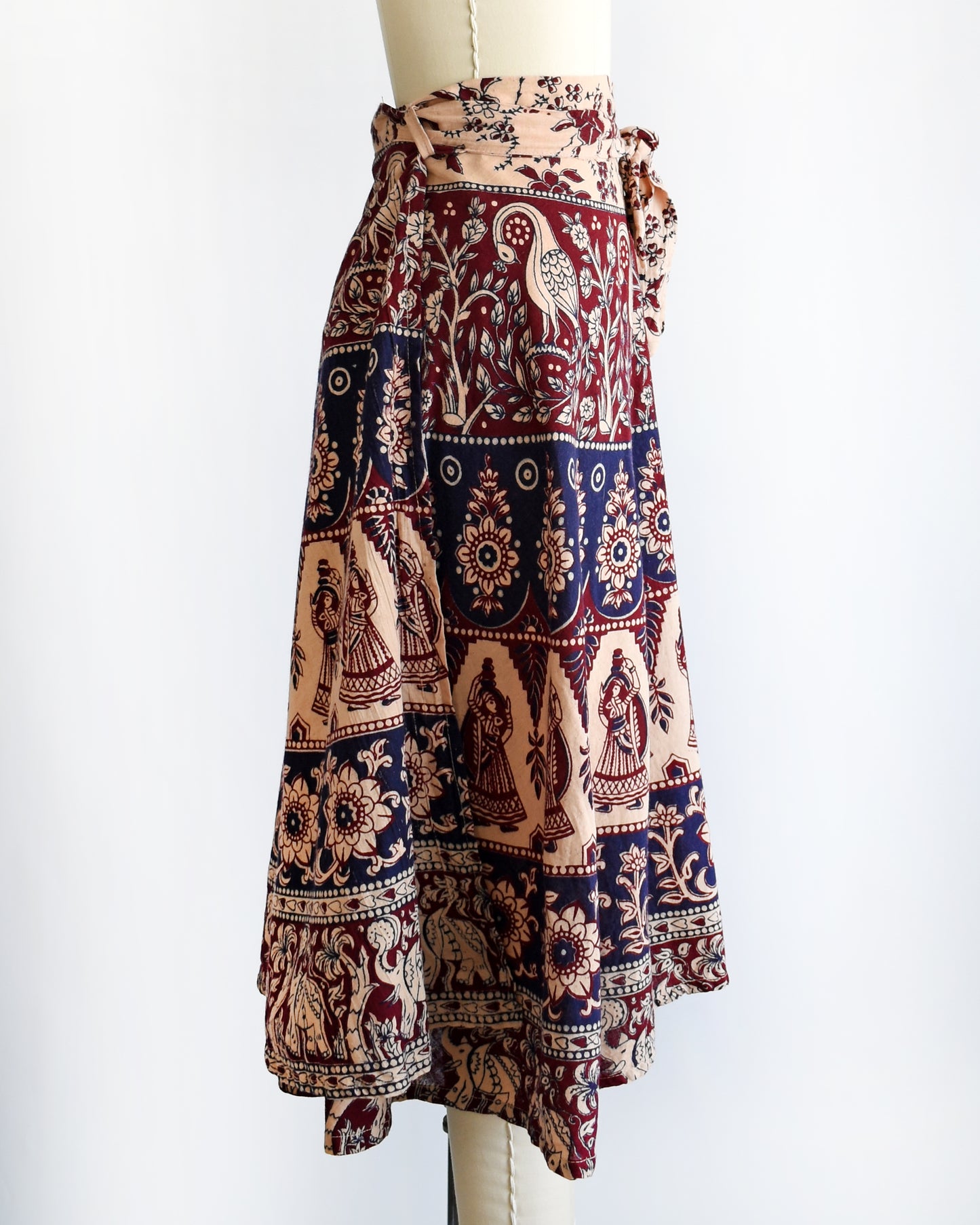 side view of a vintage 1970s block print skirt on a mannequin against a white background